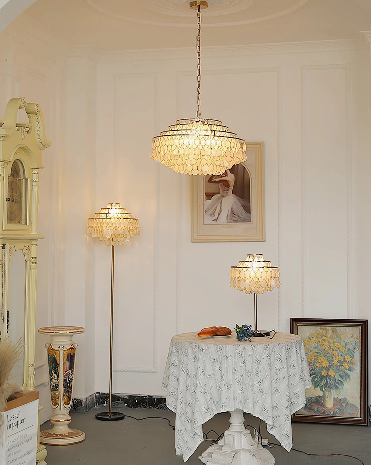 Matching shell pendant and table lamps in classic vintage home setting, wide room view with antique furniture, framed art and table setting