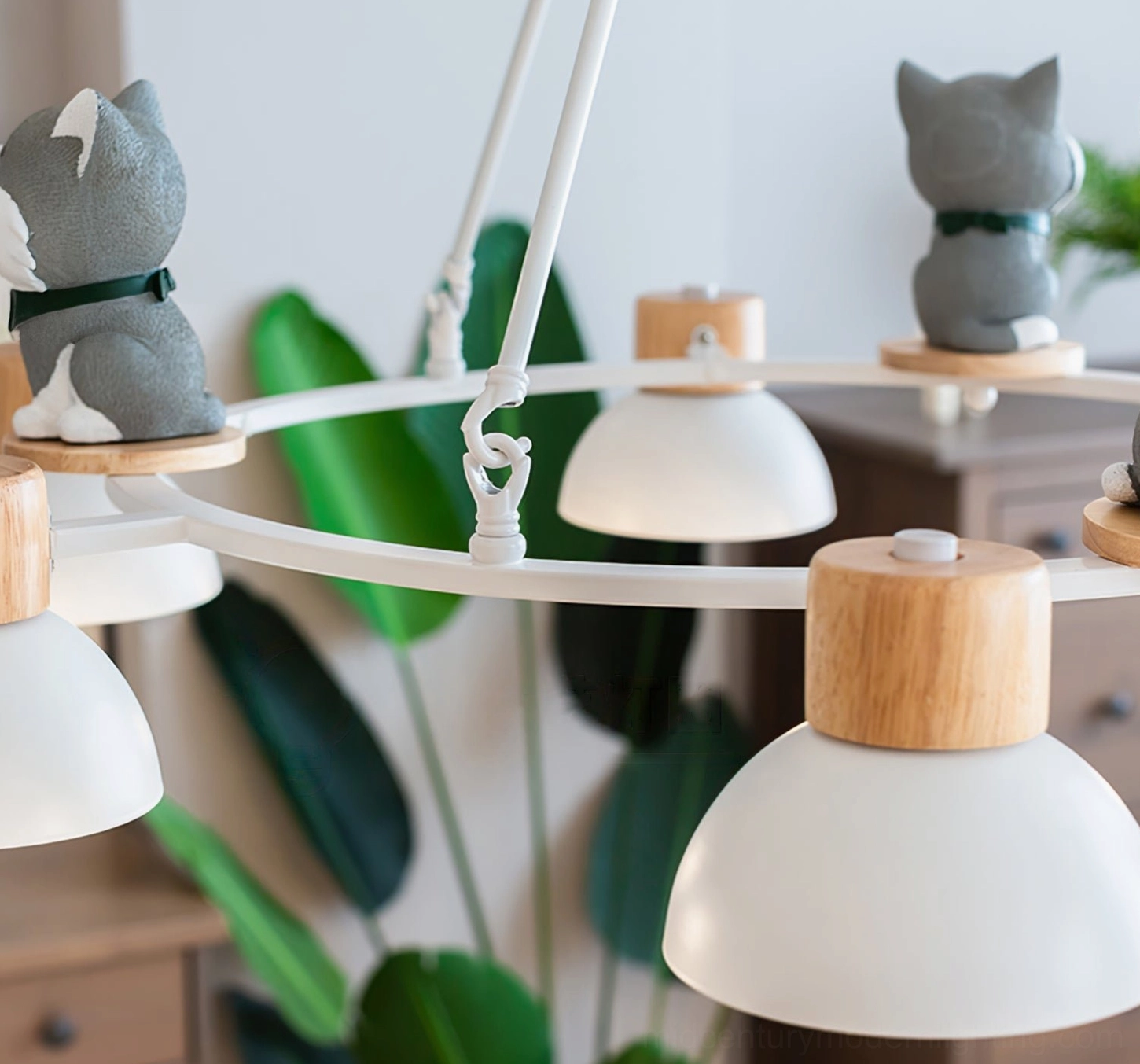 Close-up side view of Shiba Inu pendant chandelier with grey figurines and green foliage background