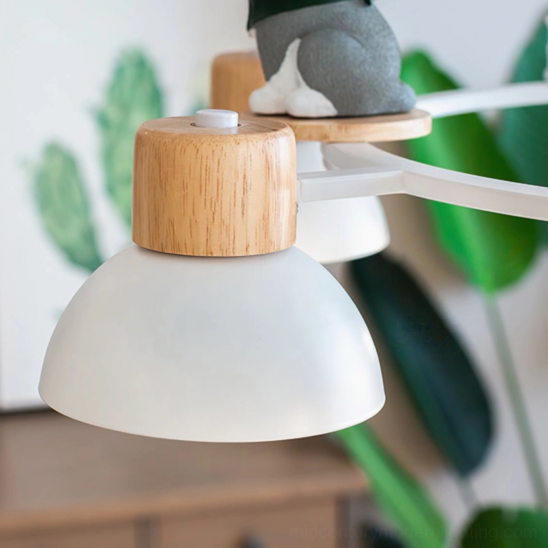 Shiba Inu chandelier lamp shade and fixture detail with solid wood base, white metal frame and green plant backdrop