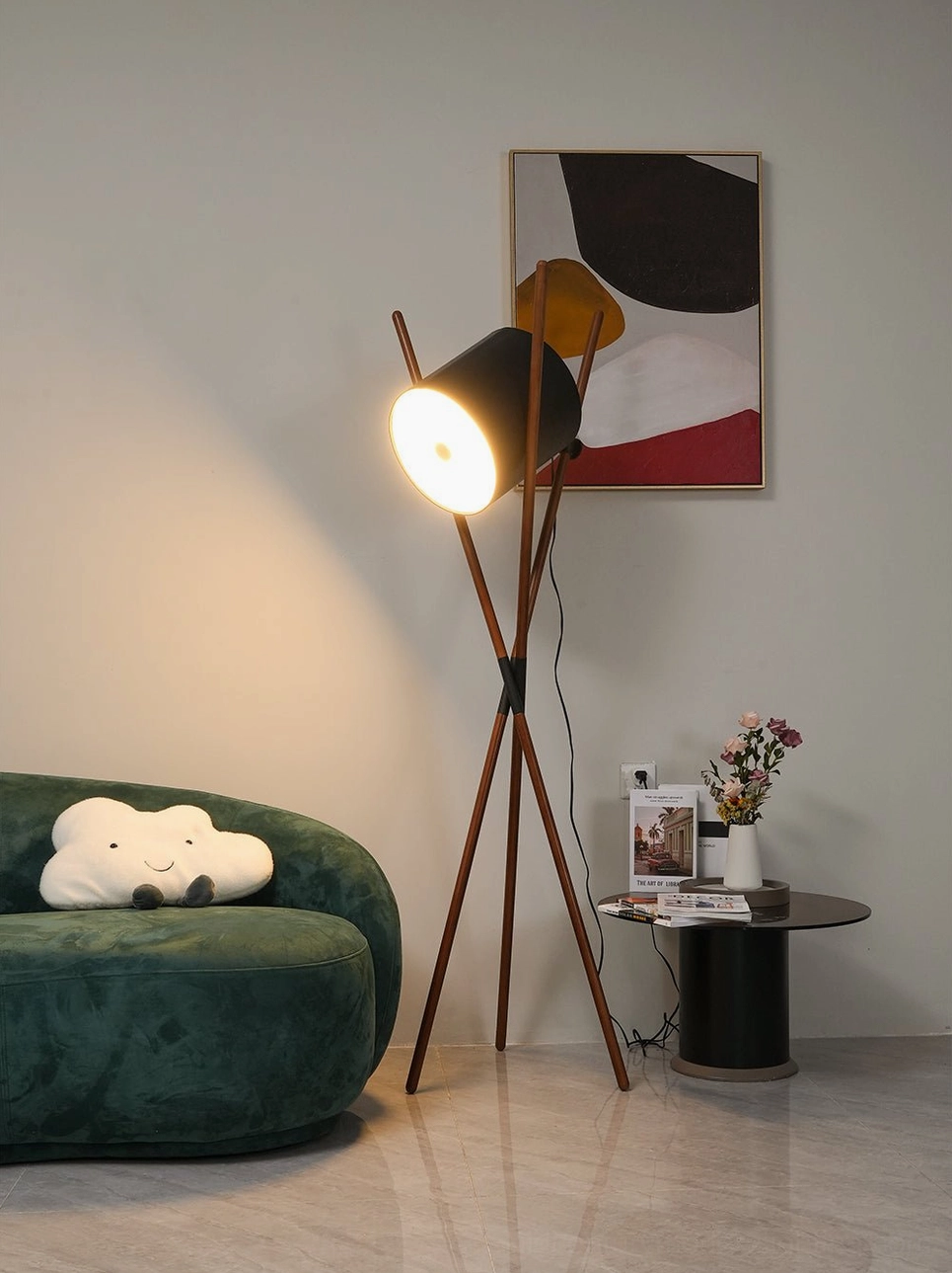 Lit Shift tripod floor lamp casting warm ambient light in mid-century modern interior