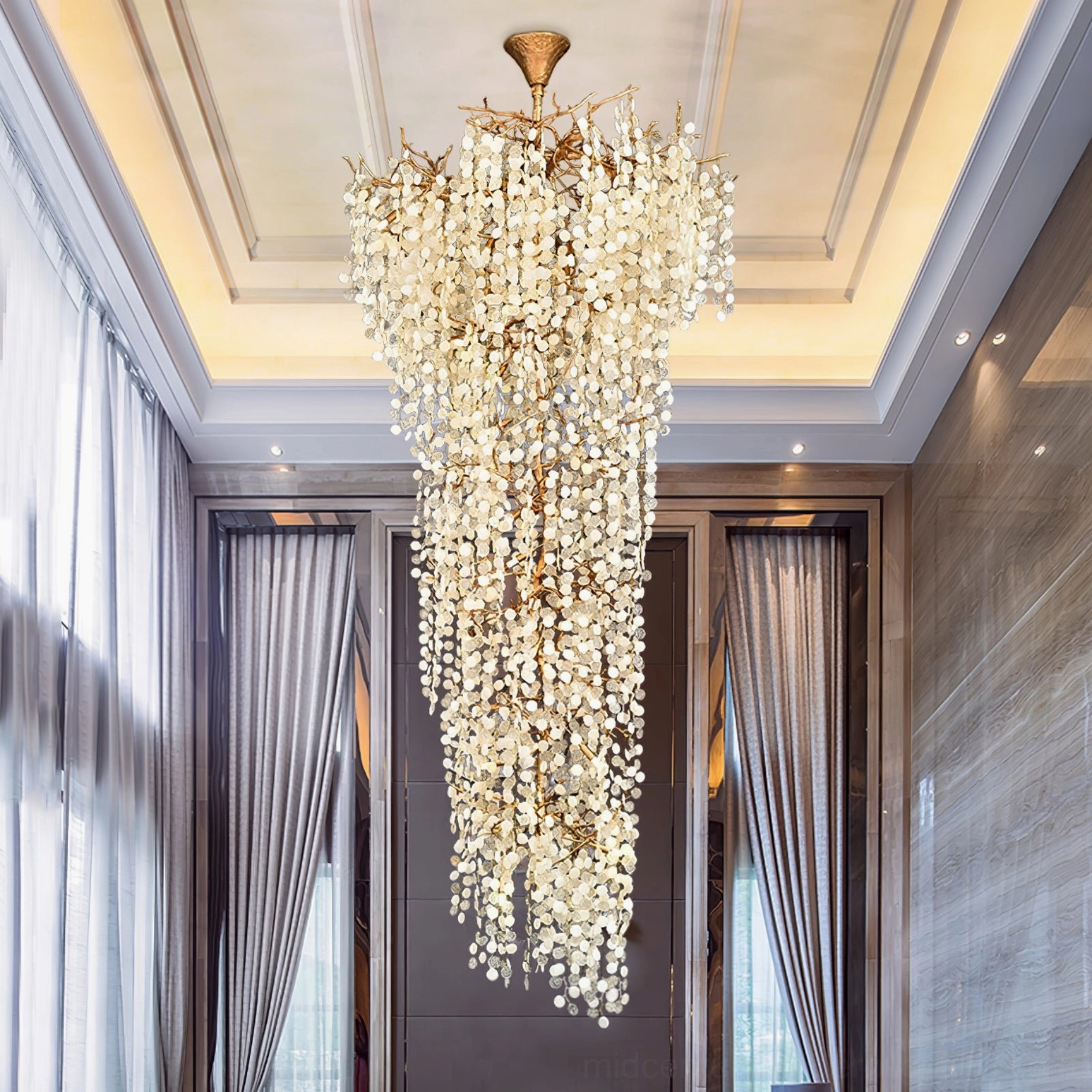 Shiro Noda chandelier installed in luxury residential lobby with floor-to-ceiling windows and dramatic vertical lighting
