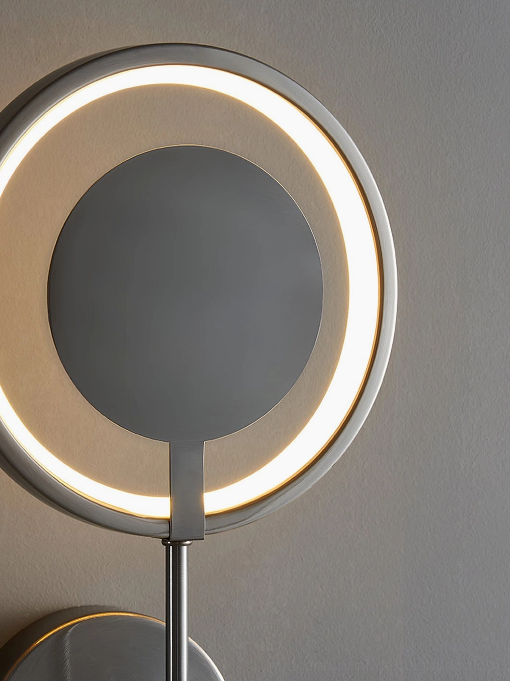 Side view of modern circular LED wall lamp showing profile and wall mounting installation method