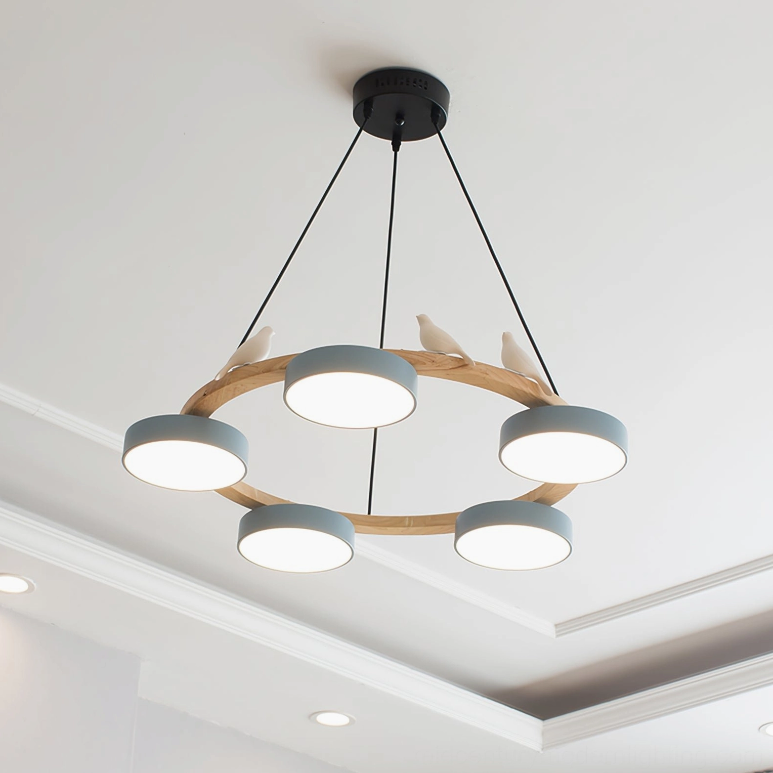 Sienna bird round pendant chandelier showing ceramic bird ornaments perched on natural wood frame edges between lamp shades