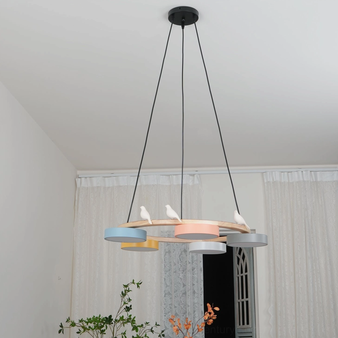 Sienna bird round pendant light installed above dining table showing warm ambient glow and visual focal point in modern interior