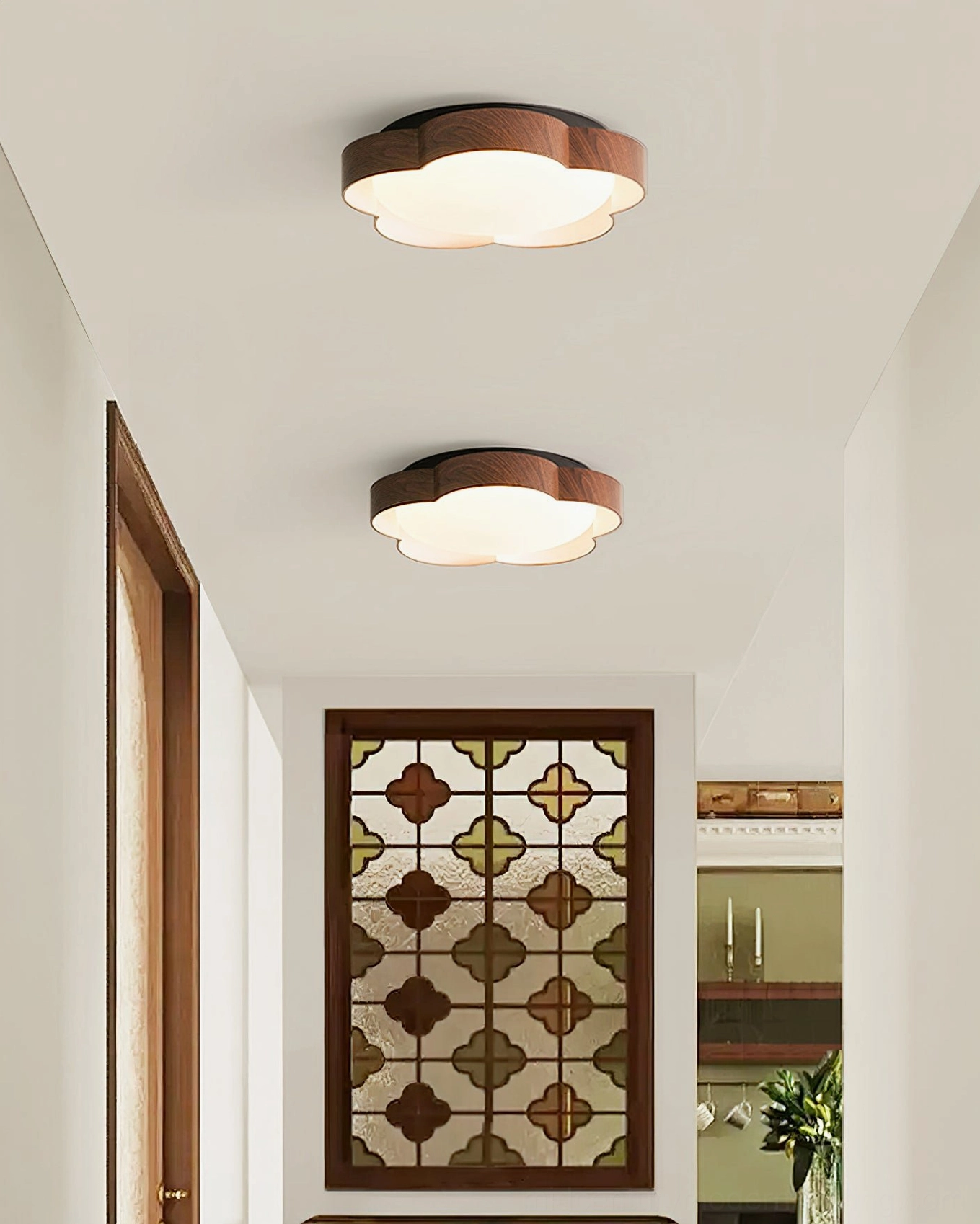 Dual matching Sika ceiling lamps in warm wood tone installed in vintage stained glass corridor