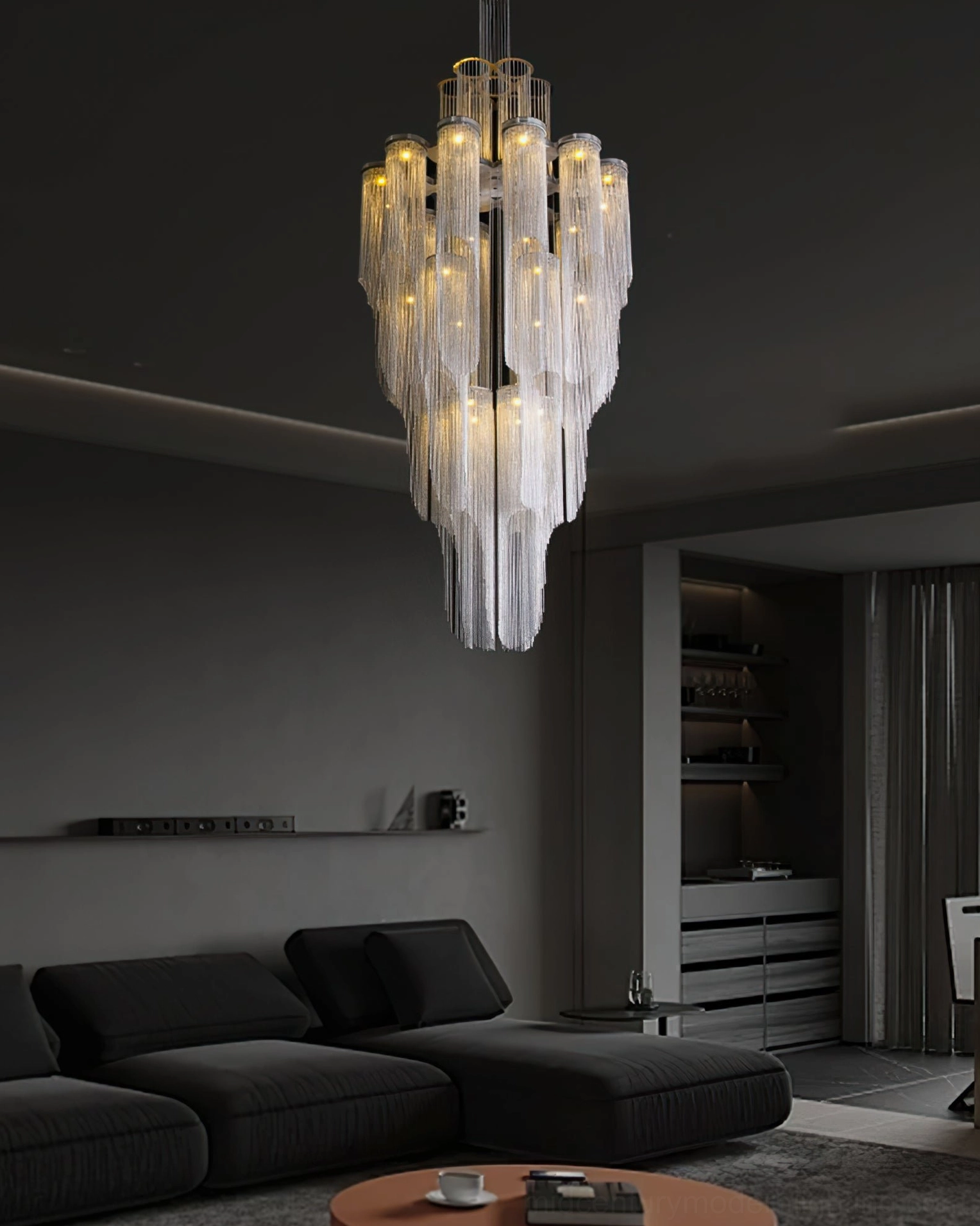 Silver tiered chandelier casting light patterns in contemporary interior design space