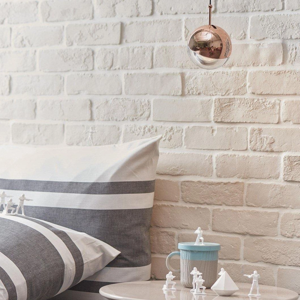 Single silver spherical pendant light close-up bedroom lounge brick wall minimalist decorative lighting