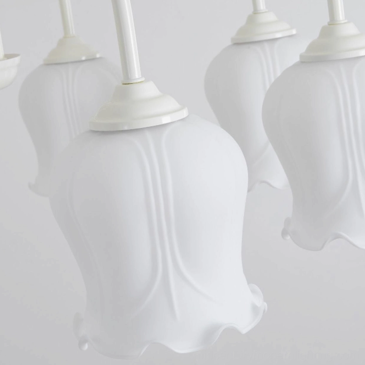 Frosted glass lily chandelier six-head configuration with white finish frame and botanical inspired design
