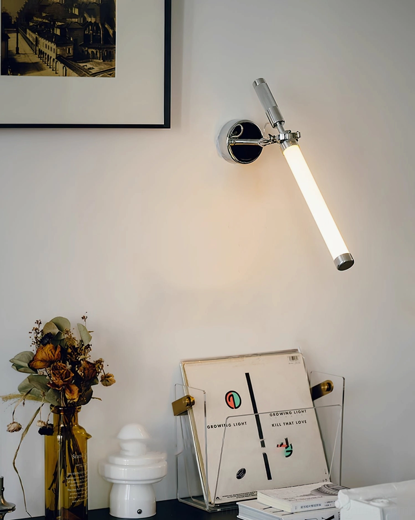 Chrome and frosted glass wall lamp demonstrating contemporary mid-century design aesthetics