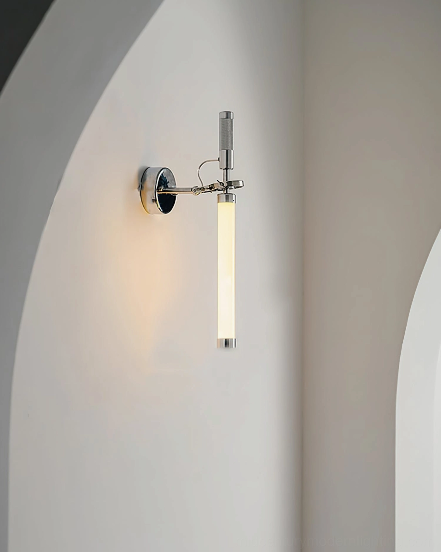 Contemporary wall sconce with chrome base, frosted glass, and sculptural minimalist form