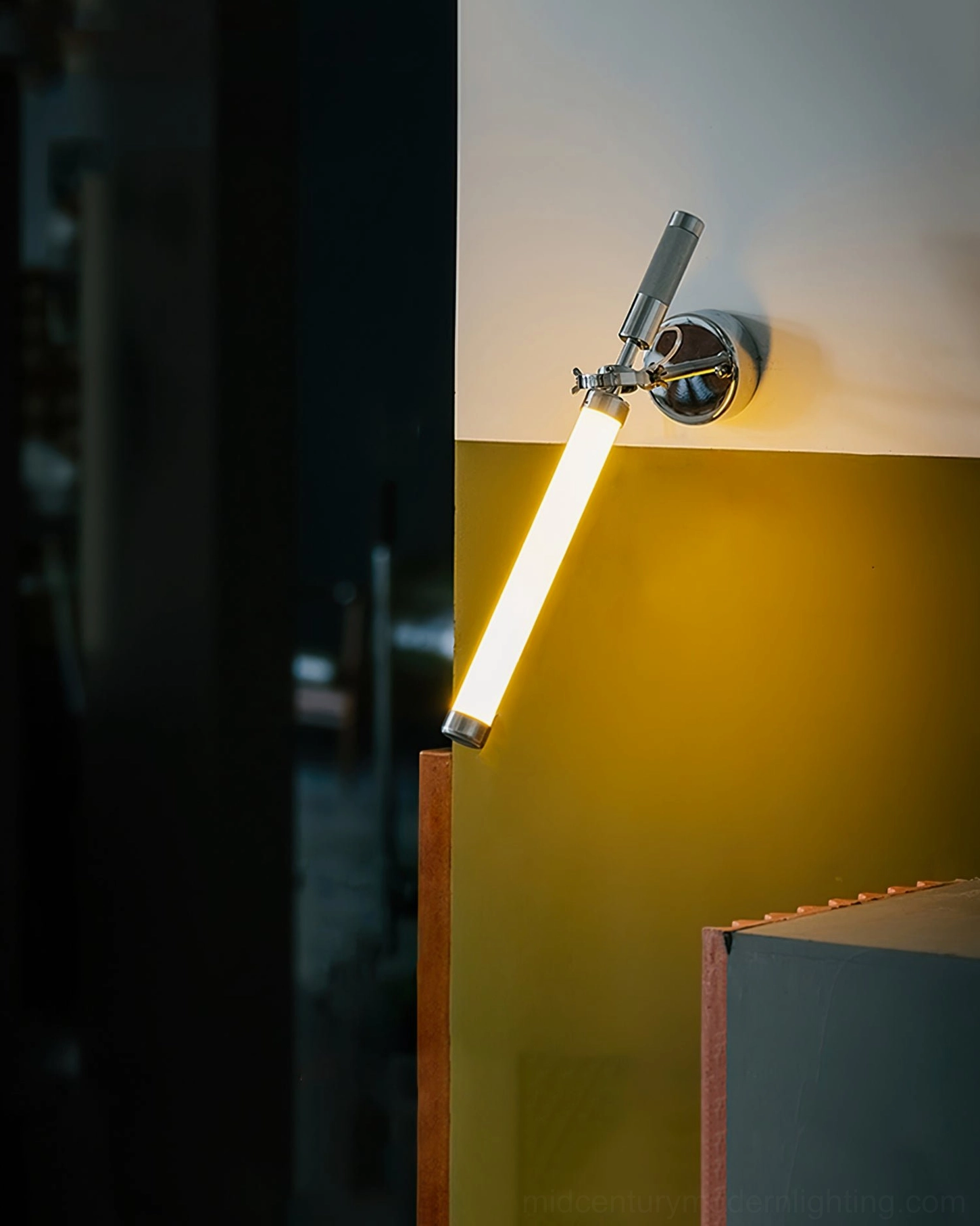 Sleek wall-mounted lamp with rotating arm and frosted glass diffuser for task or accent lighting