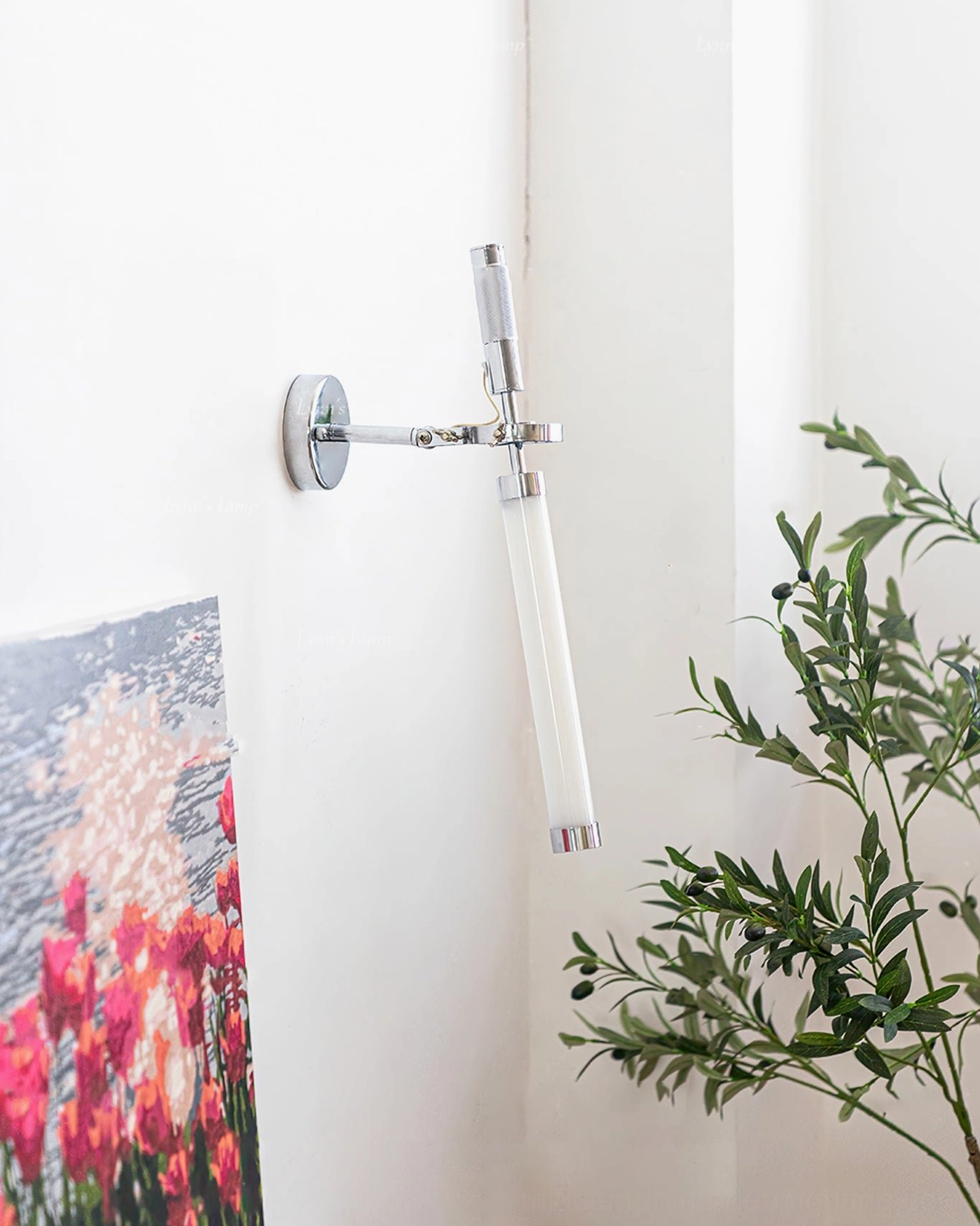 Modern wall-mounted sconce with chrome hardware and frosted glass shade, interior styling view