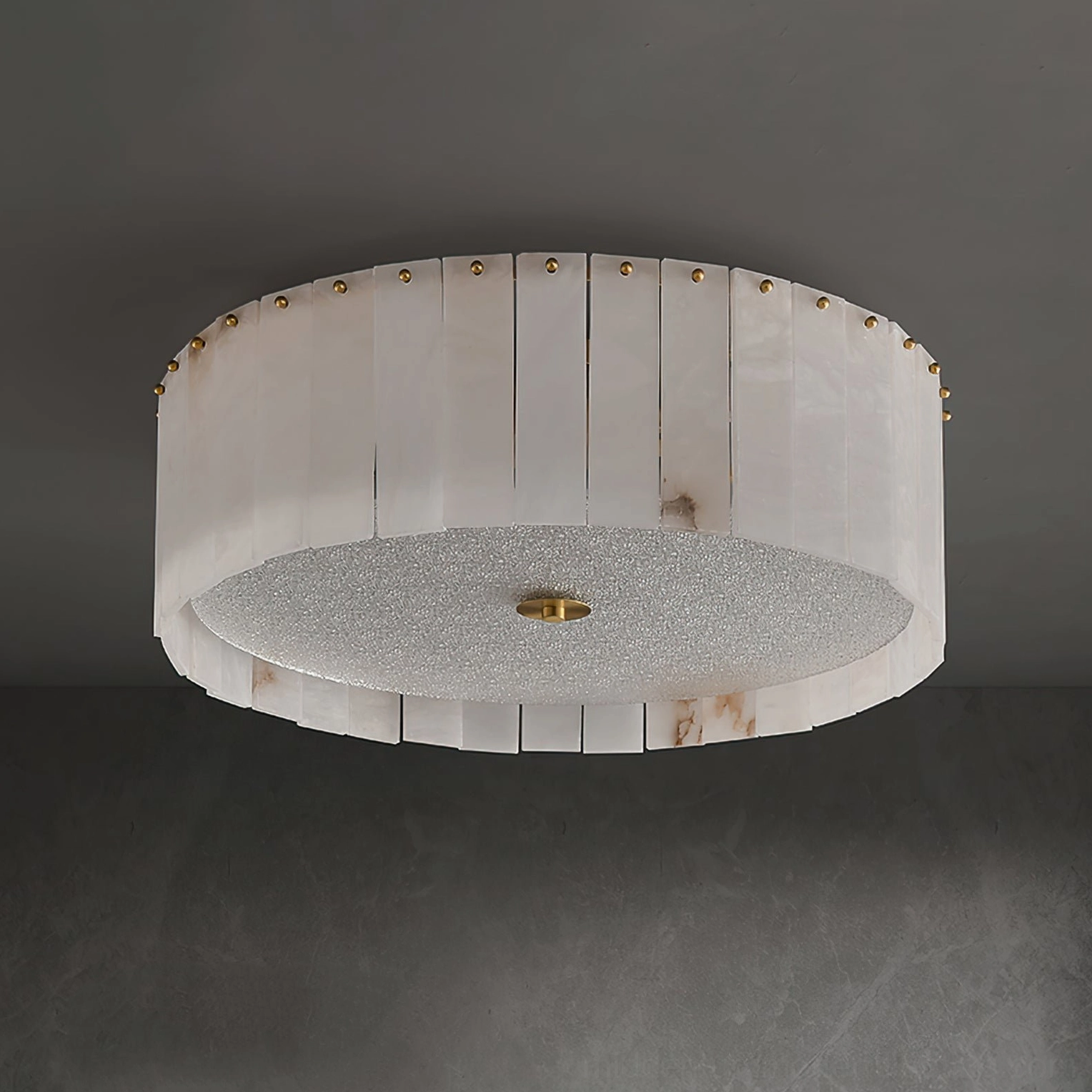 Bottom view of slatted alabaster shade with brass stud accents on mid-century light fixture