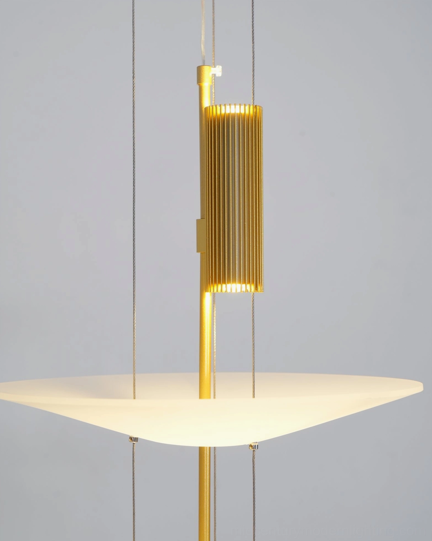 Sleek modern pendant light fixture suspended above contemporary furniture in open-plan home space