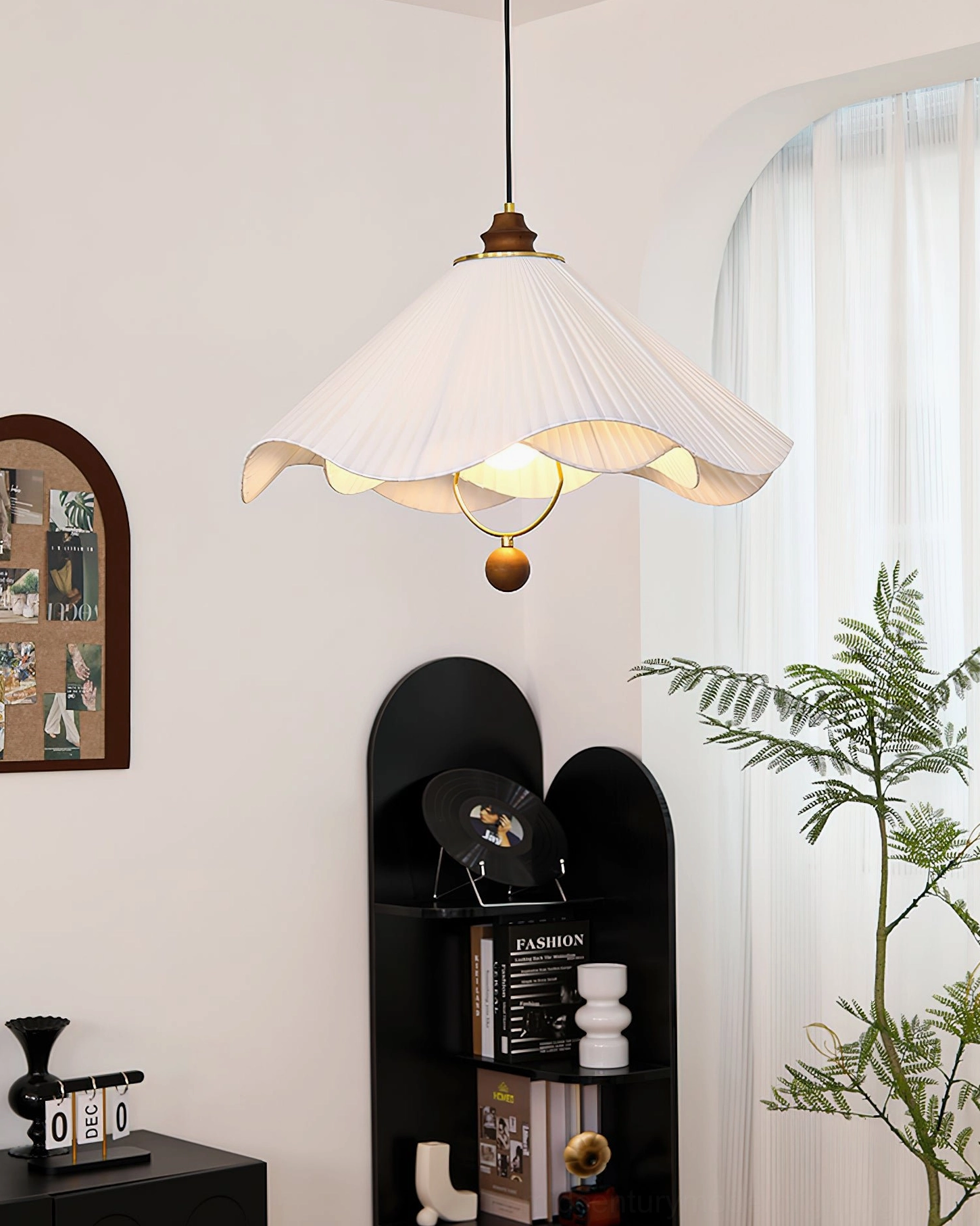 Sloane pendant light left side view in cozy minimalist living room with arched shelf decor matching mid-century modern styling