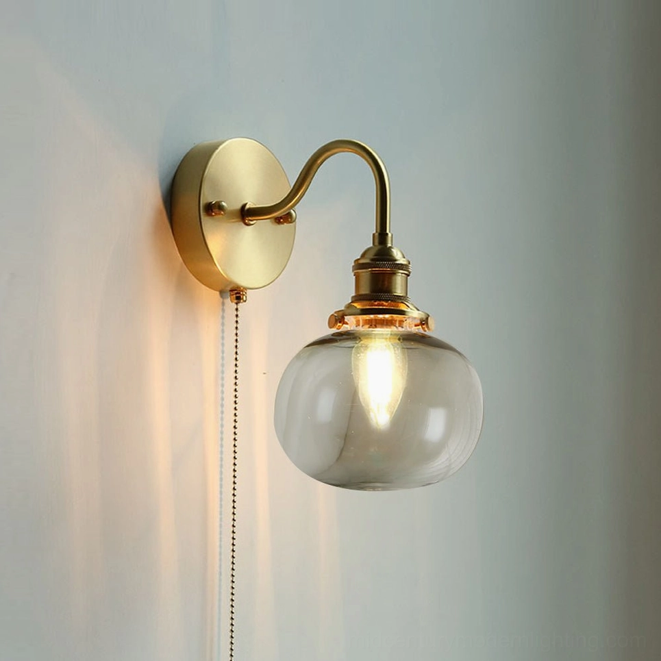 Smoke gray glass brass wall sconce with moody ambient lighting - sophisticated mid-century wall lamp