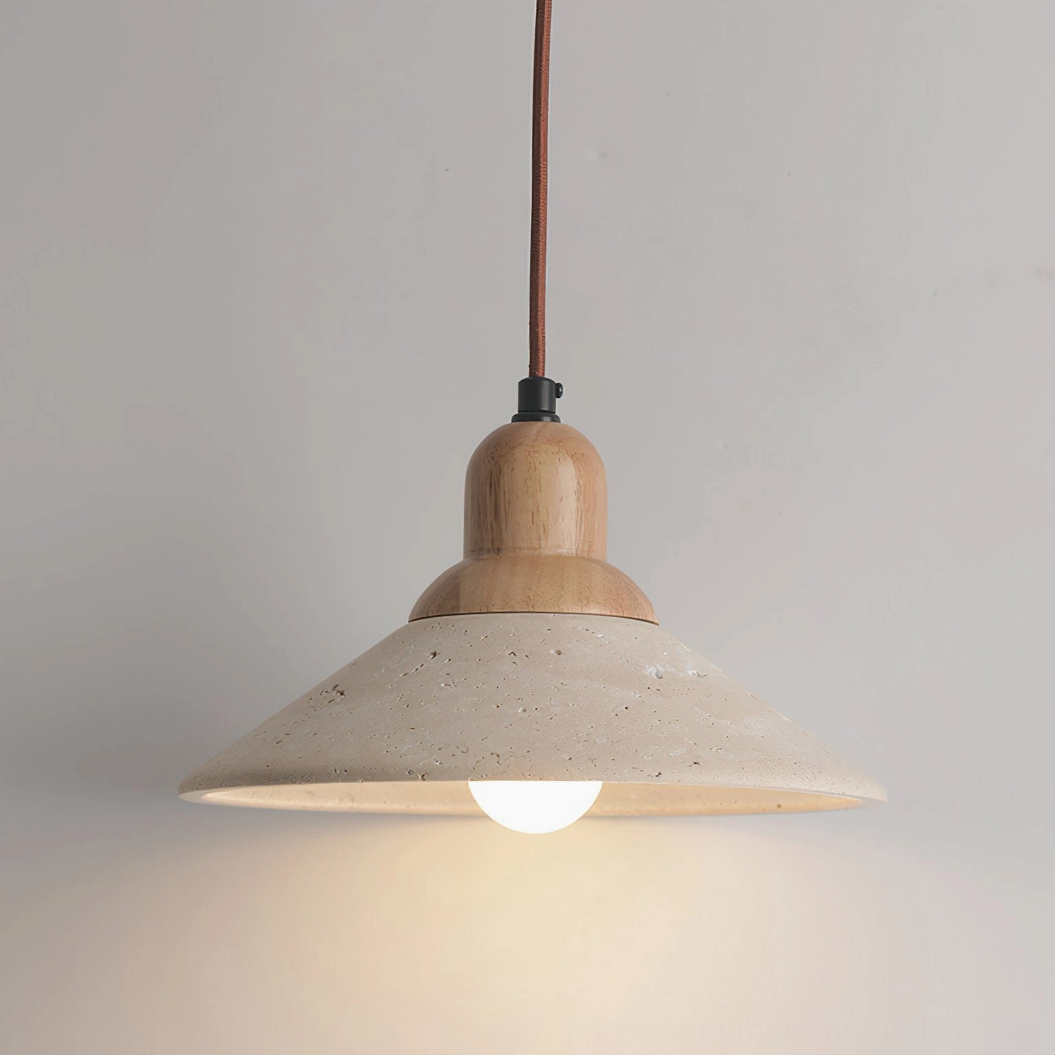 Solara travertine pendant light angle view emphasizing natural stone texture and minimalist japanese design