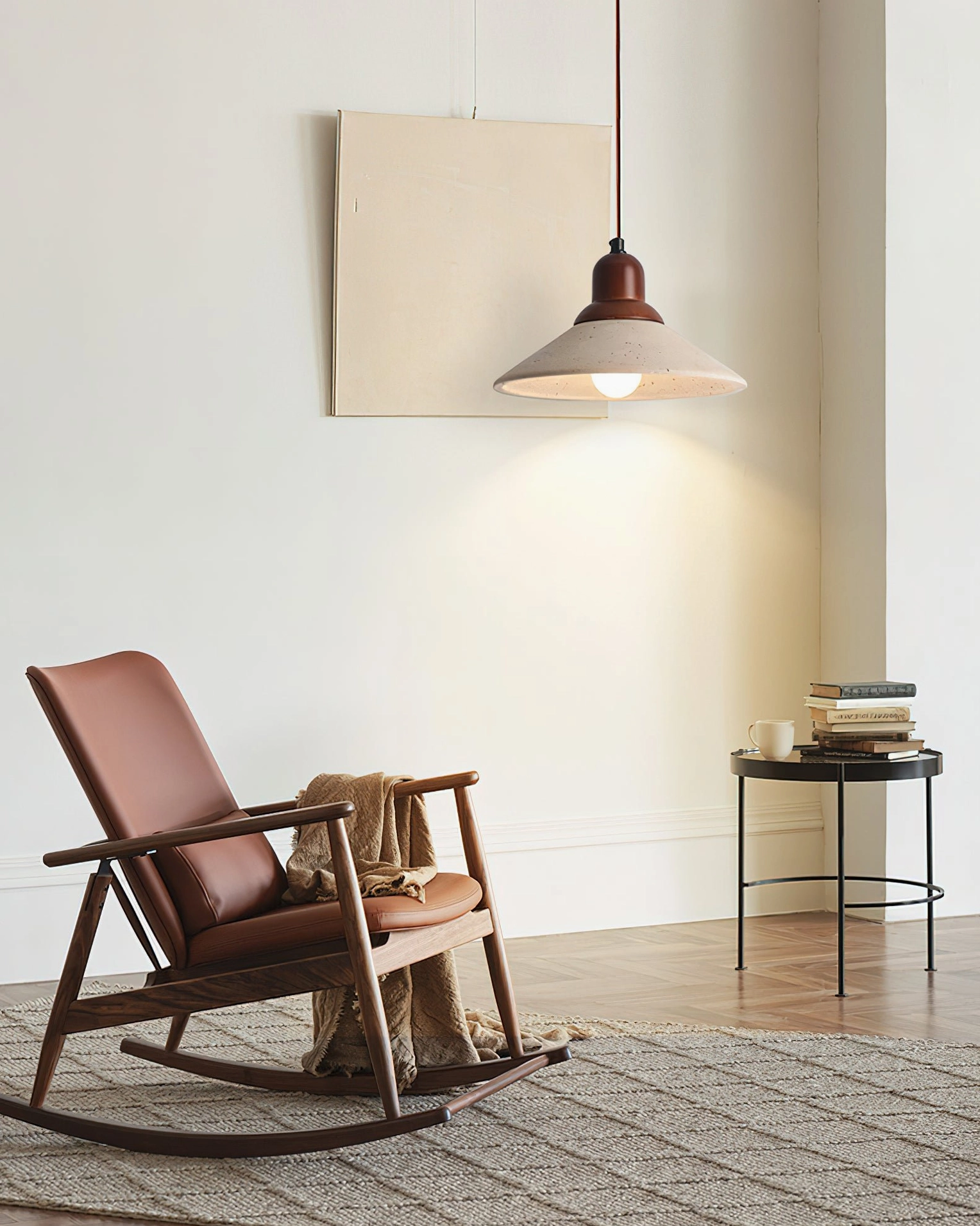 Solara pendant illuminating modern living room with rocking chair and neutral wabi-sabi decor