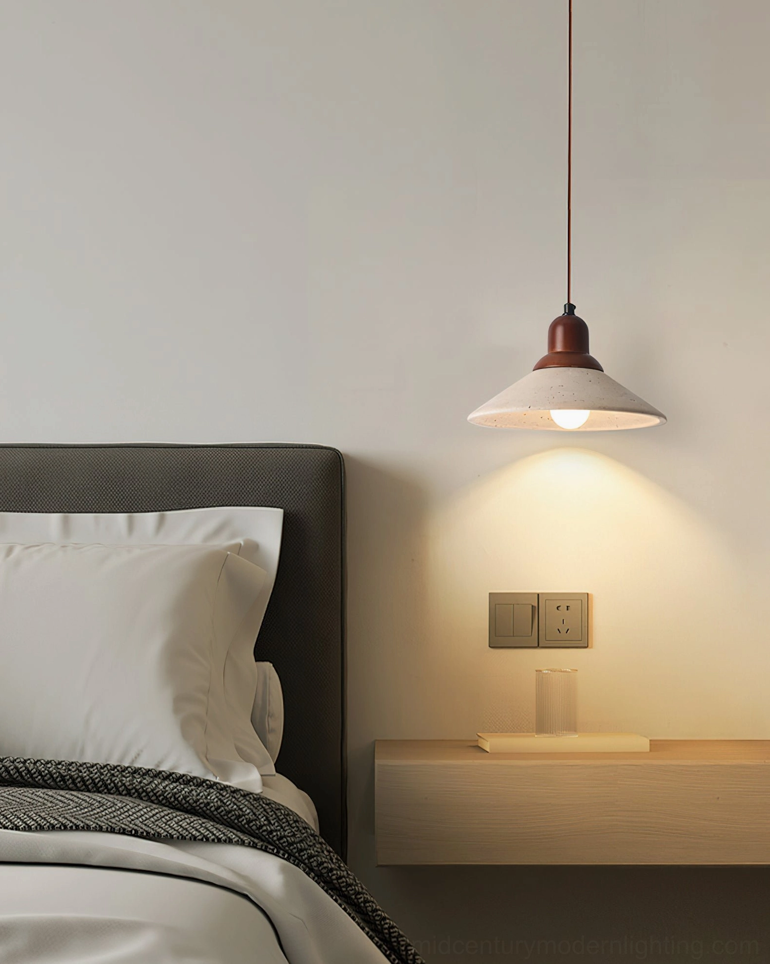 Solara pendant suspended above bedroom bedside with upholstered headboard and wall shelf