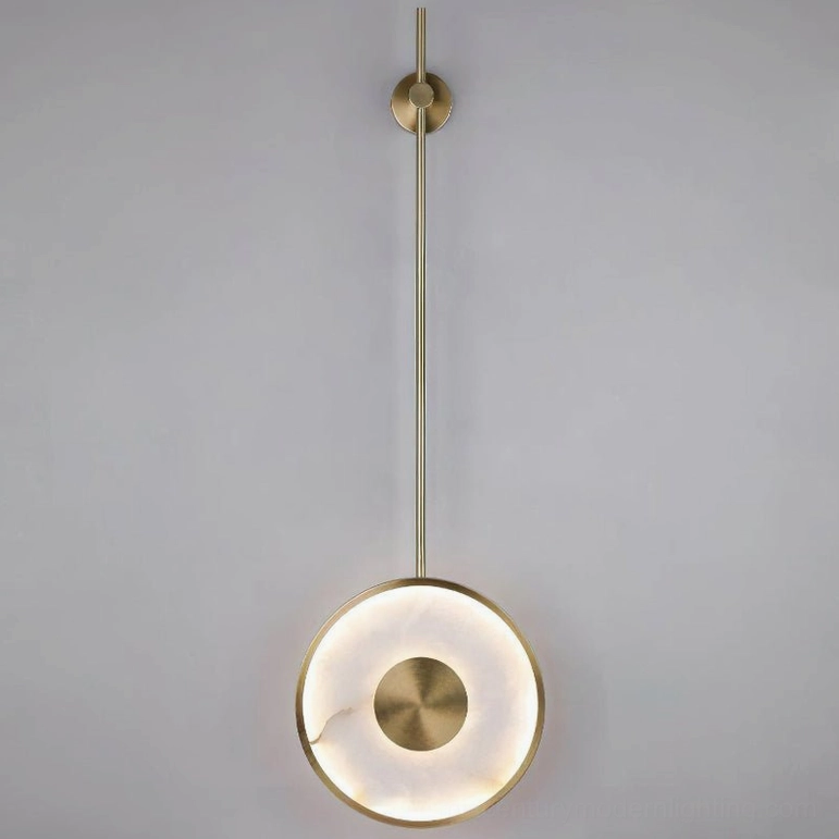 Sorle alabaster wall lamp unlit front view, showcasing brushed brass finish and alabaster disc geometry