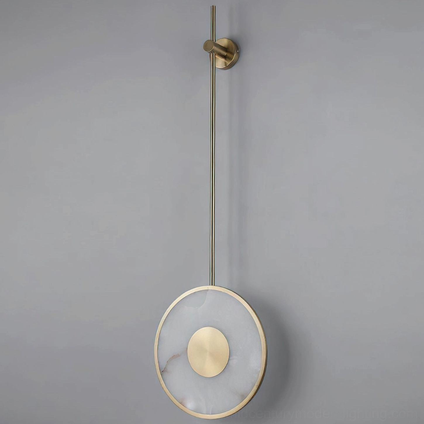 Sorle alabaster wall lamp front view with brass center disc, clean minimalist sculptural design