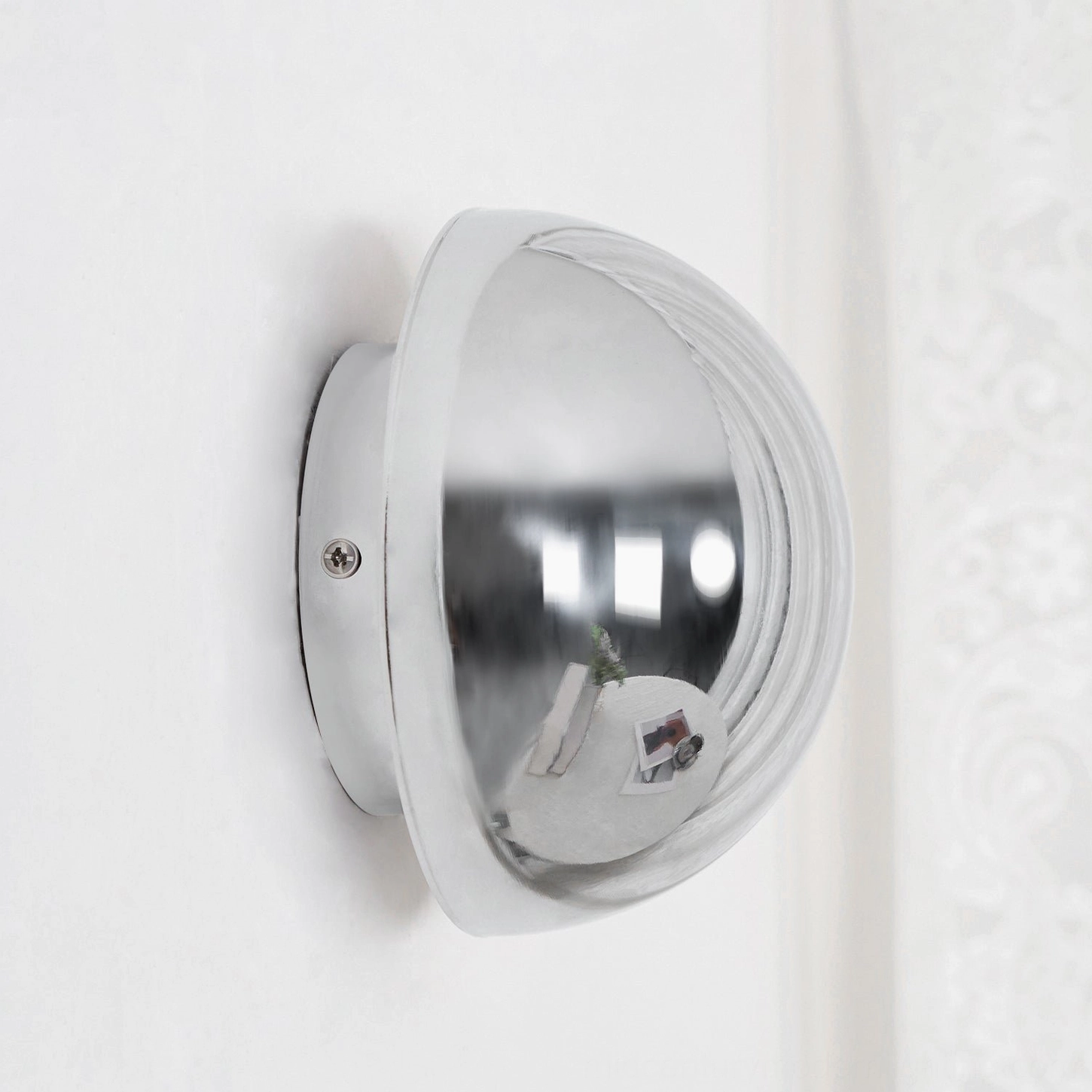 Side profile view of modern sphere wall sconce showing 3D rounded metal construction