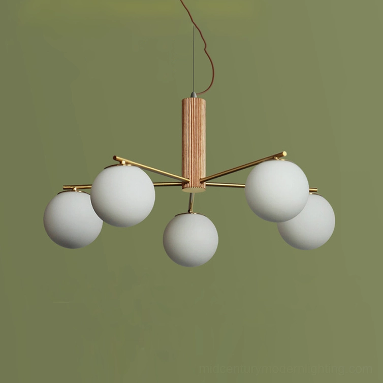 Macy sputnik chandelier close-up showing frosted white glass orbs and brass frame construction