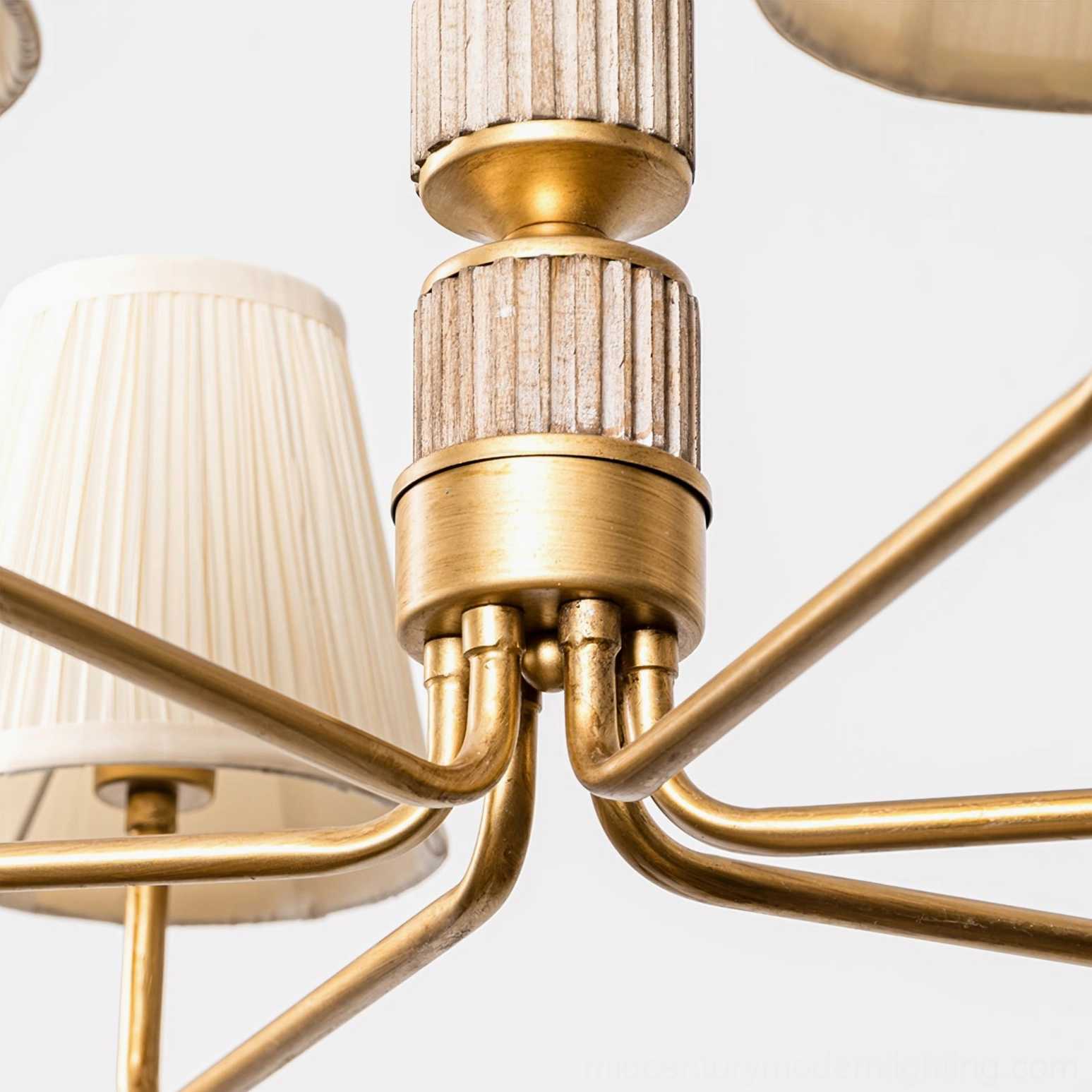 Stacey chandelier arm and hardware side close-up detail with brass gold metal frame, fluted wooden central decor and pleated shades