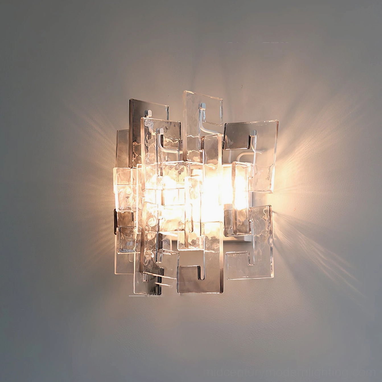Stagger cast glass sconce smoky gray variant front lit ambient glow dark metal frame