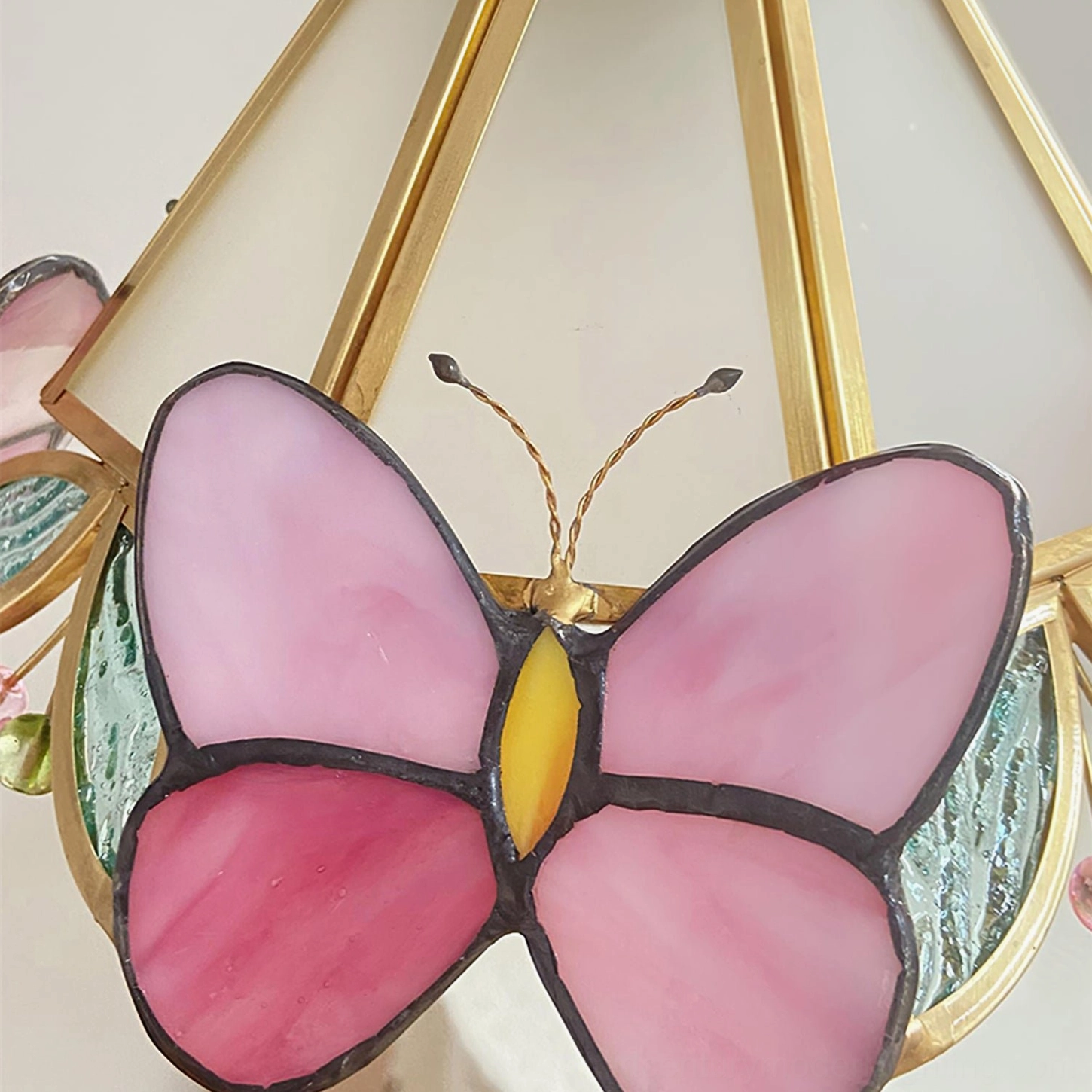 Hand-Painted Stained Glass Butterfly Detail with Black Outline and Golden Body - Close-Up