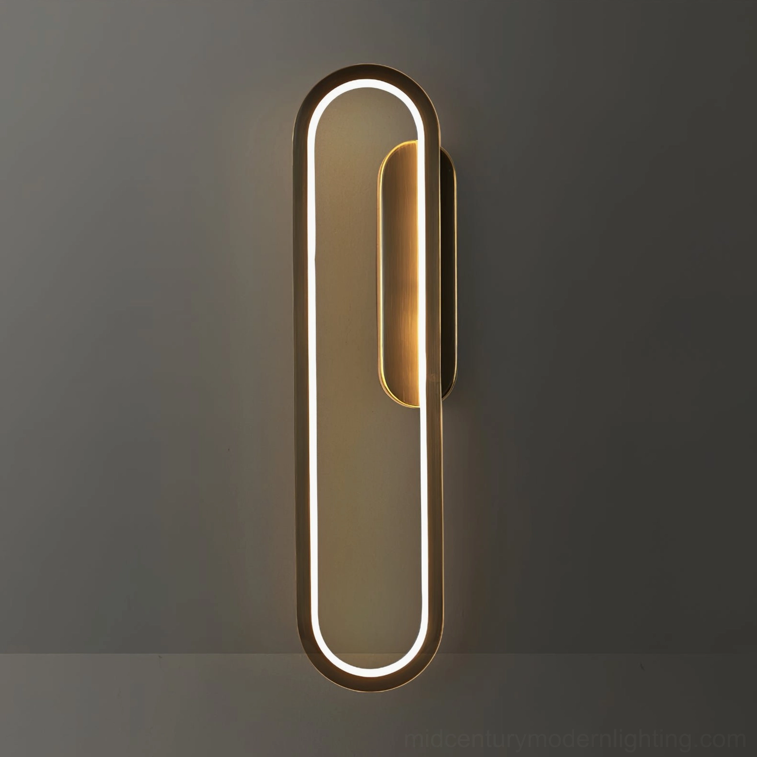 Vertical elongated oval LED wall lamp mounted on dark gray interior wall showing modern minimalist design