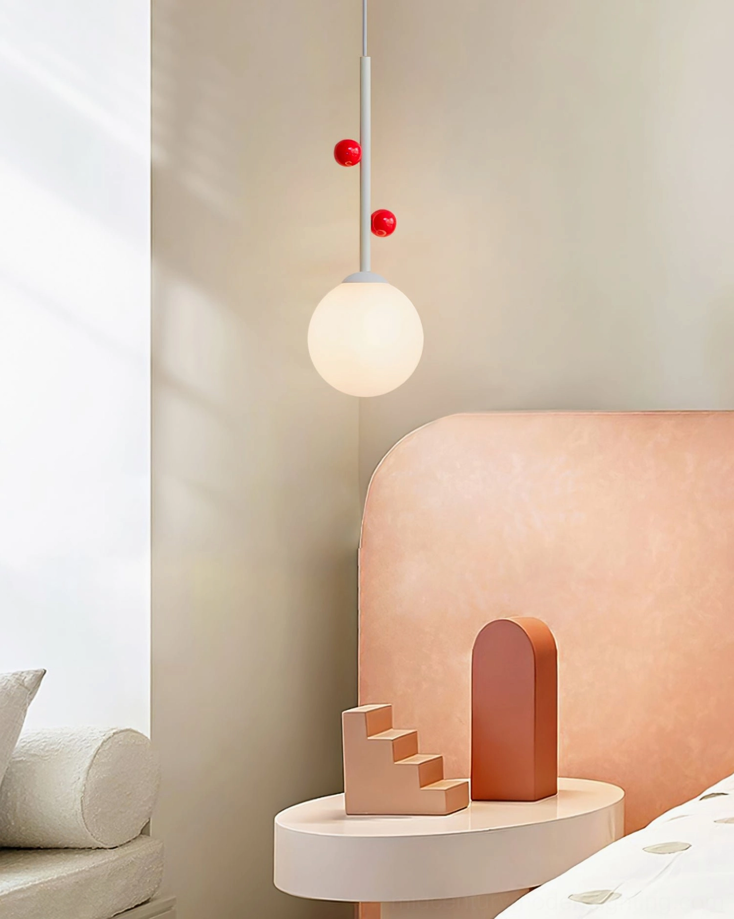 Hanging Stax pendant lamp in pastel bedroom with pink upholstered headboard and small round table