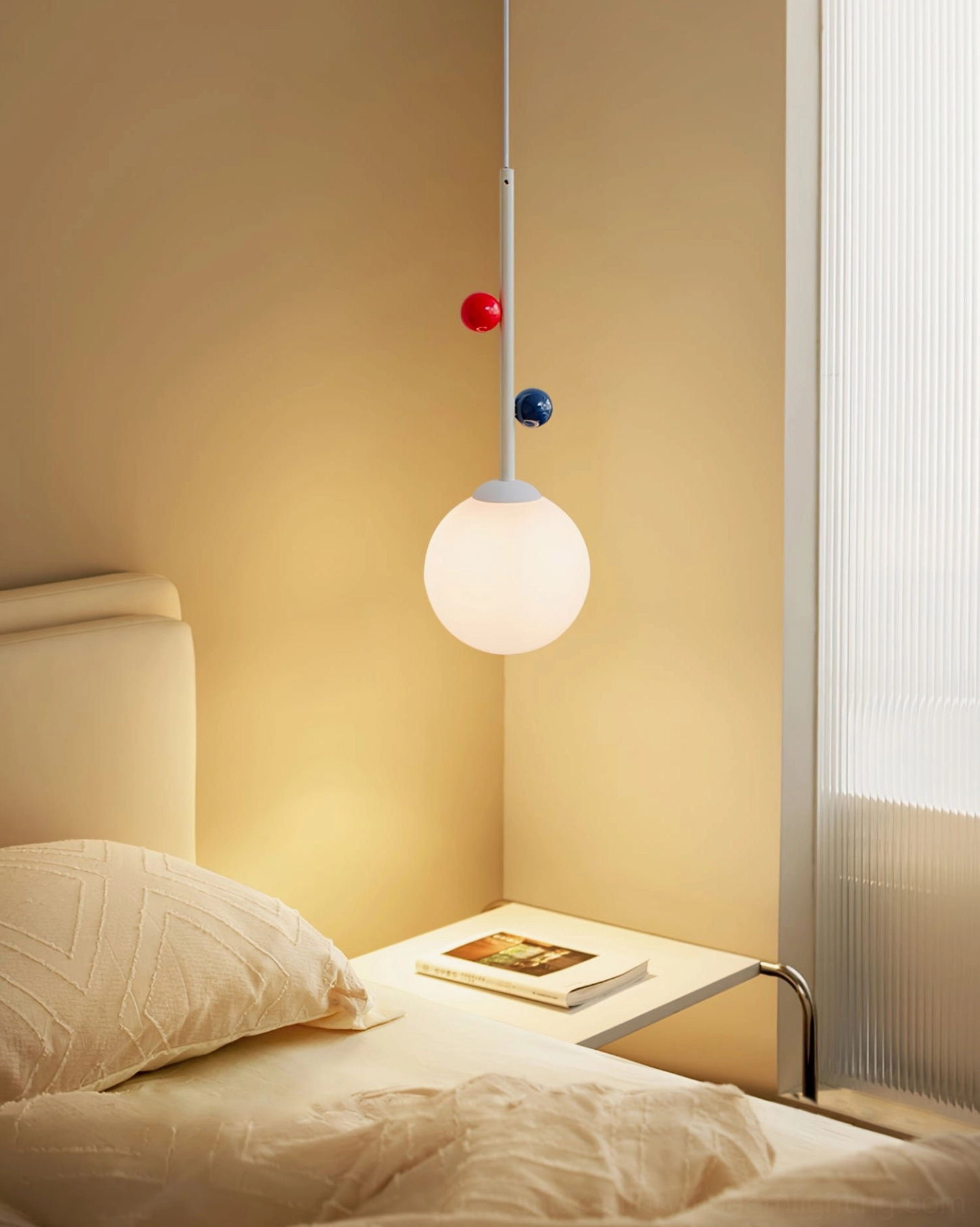 Illuminated Stax pendant lamp with warm color temperature in cozy master bedroom with beige linen bedding
