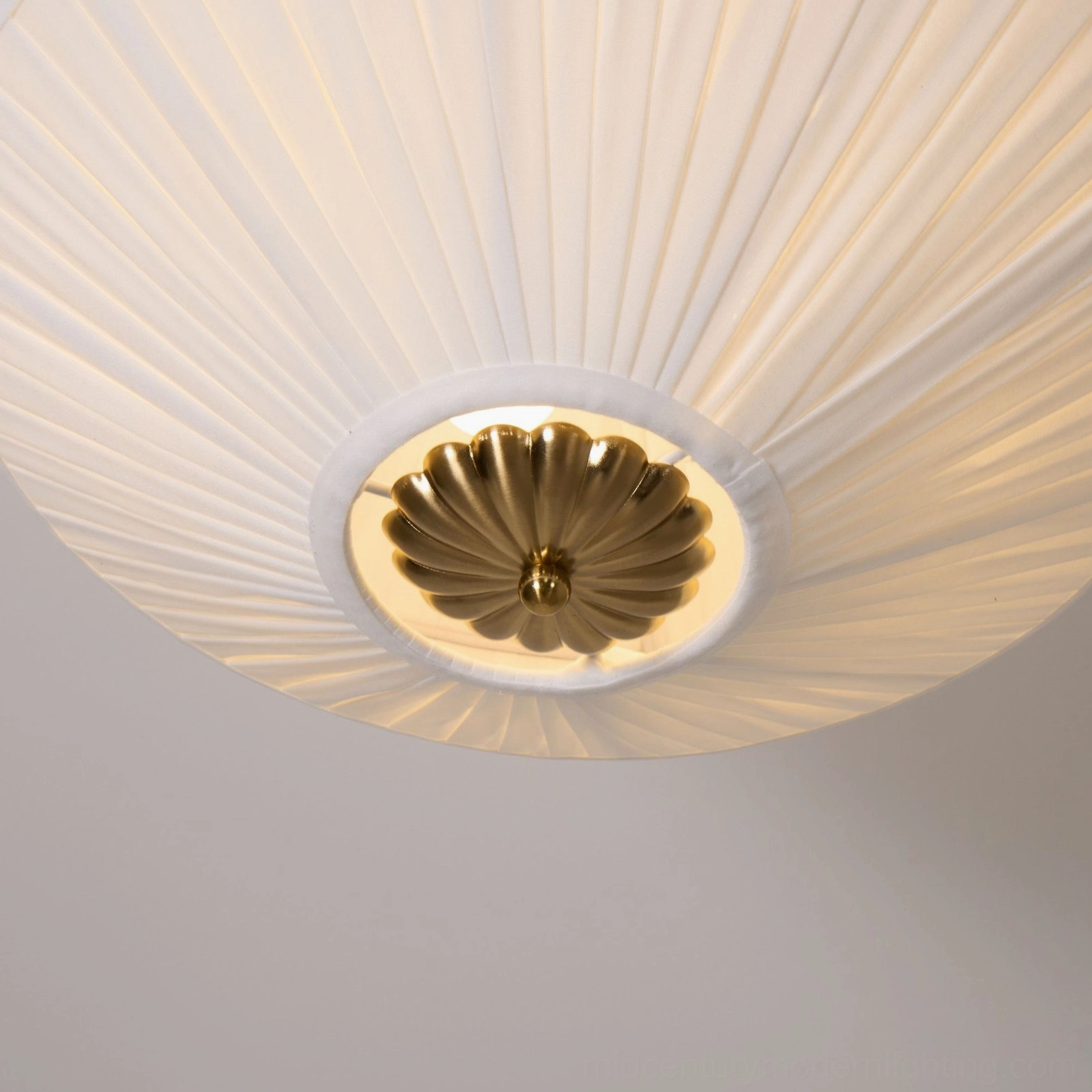 Stefanie pleated semi-flush ceiling lamp showing warm ambient lighting and sculptural pleated shade design