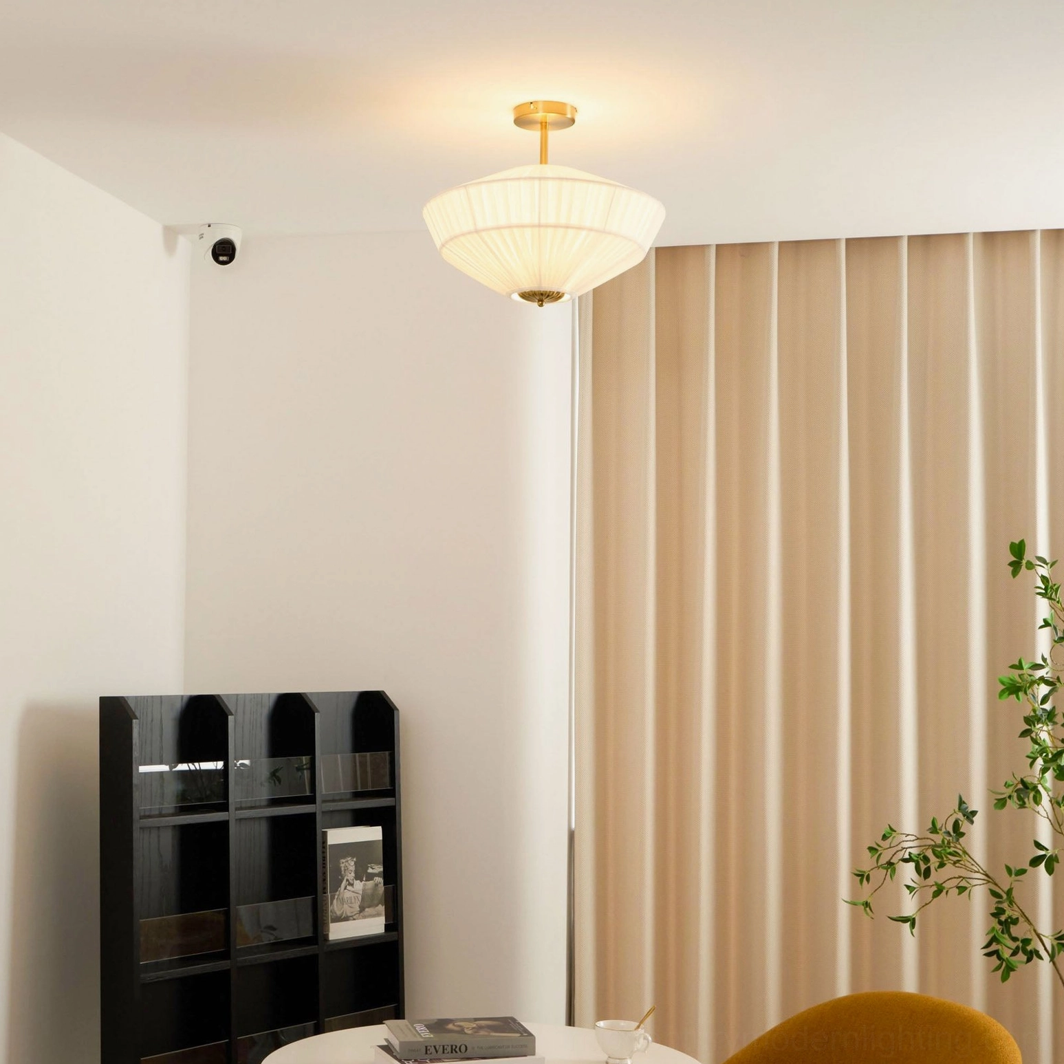 Stefanie pleated ceiling fixture in modern living space showing fabric shade texture and brass hardware detail