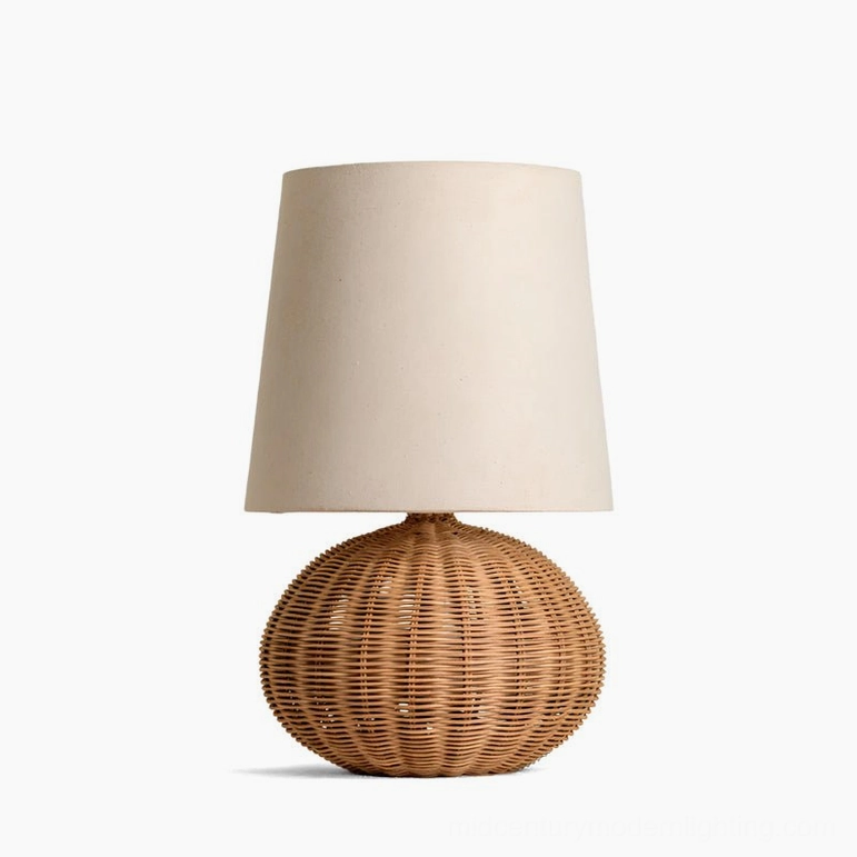 Compact size Stellan rattan table lamp with spherical woven base and soft fabric shade in natural finish