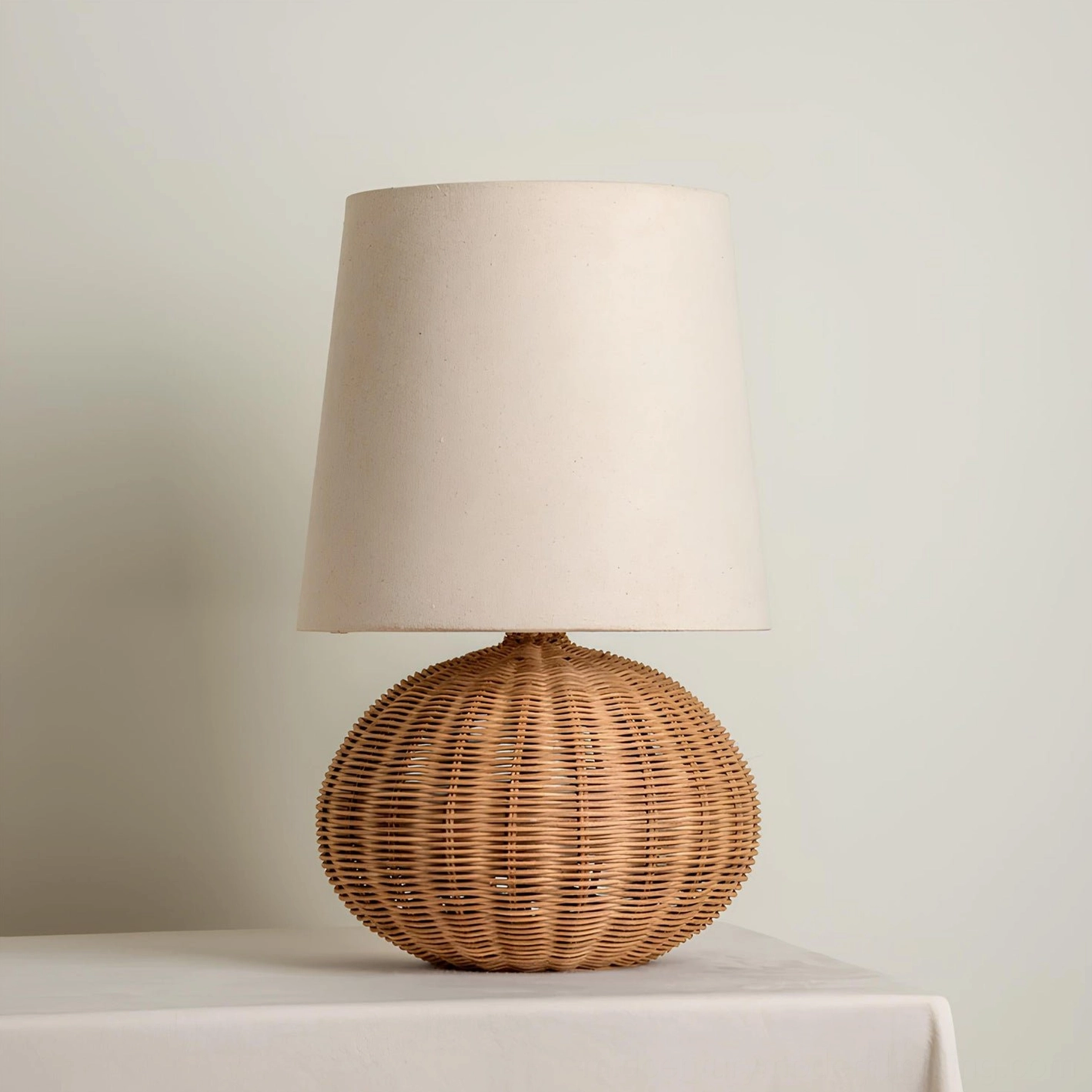 Stellan rattan table lamp styled in minimalist interior setting, complementing mid-century modern décor