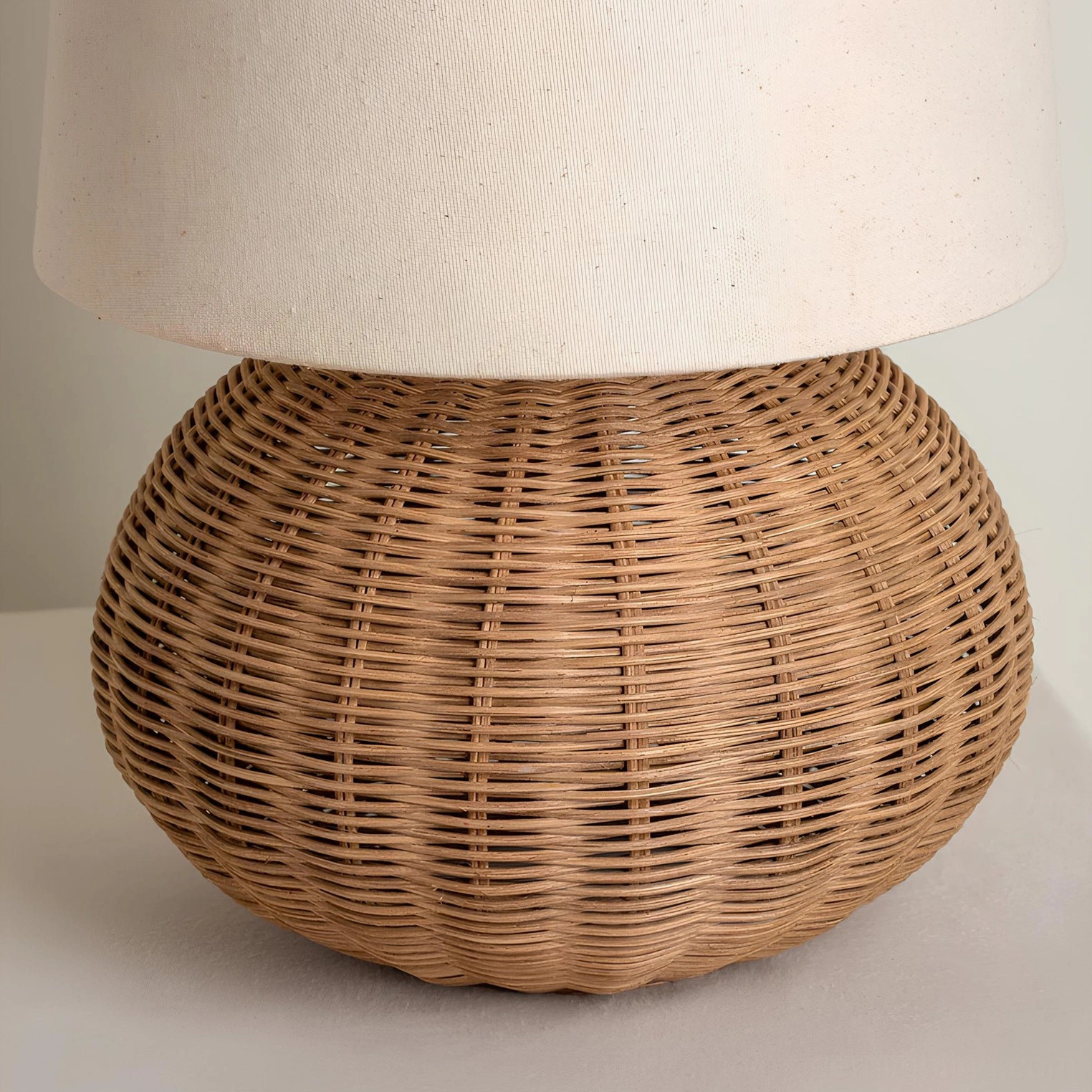Close-up detail of Stellan rattan lamp showing handwoven rattan texture, wicker weave pattern, and large cylinder shade