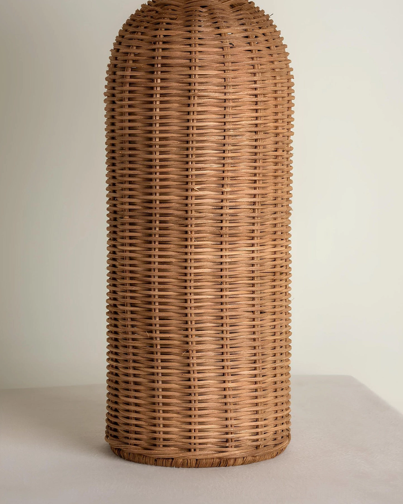 Stellan rattan table lamp in neutral living space, demonstrating versatility with Scandinavian and bohemian design