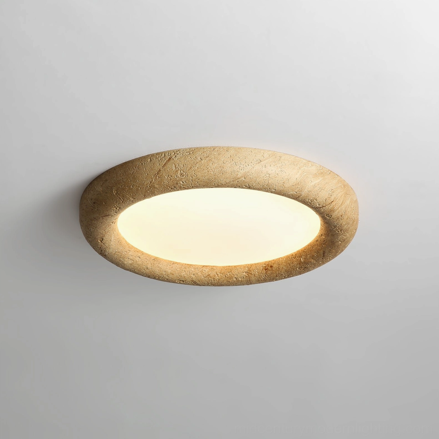 Close-up detail of warm LED glow through frosted acrylic diffuser on stone texture flush mount