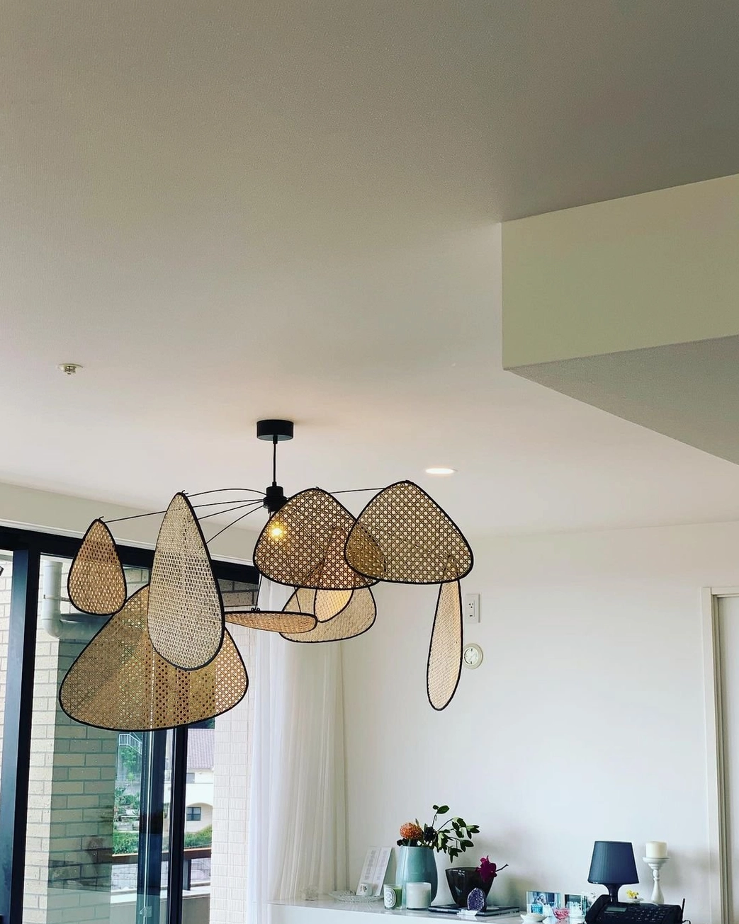 Sustainable handcrafted rattan pendant light, organic woven design emphasizing eco-friendly lighting solution