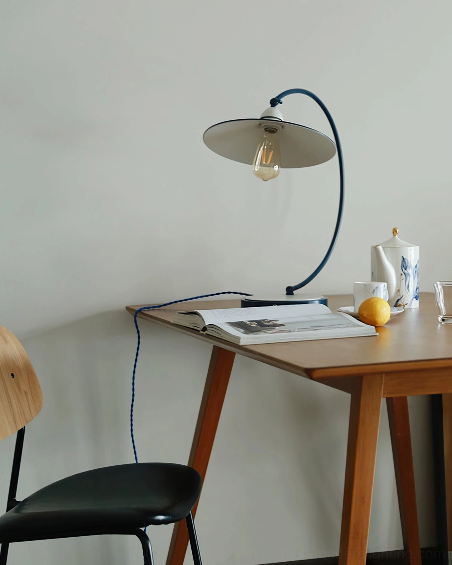 Swan Blue Table Lamp in minimalist home workspace - eye-level side view with neutral tone interior design