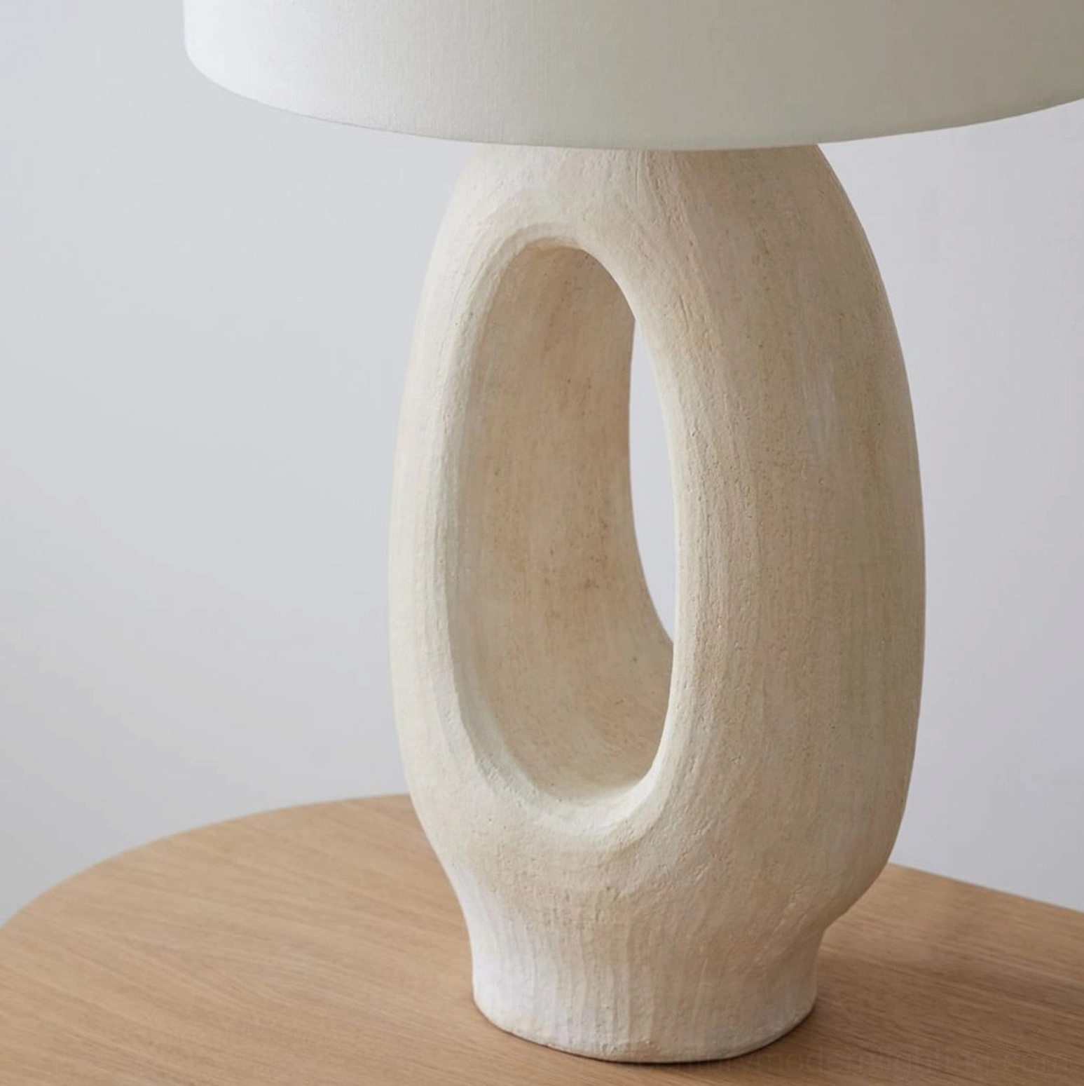 Sauce table lamp creating atmospheric ambient light through hollow cutout ceramic base design