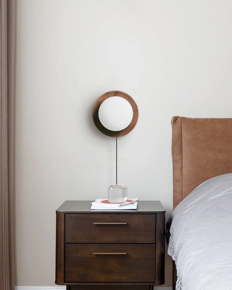 Illuminated Tablet wooden wall lamp with frosted glass shade creating diffused ambient light in home setting