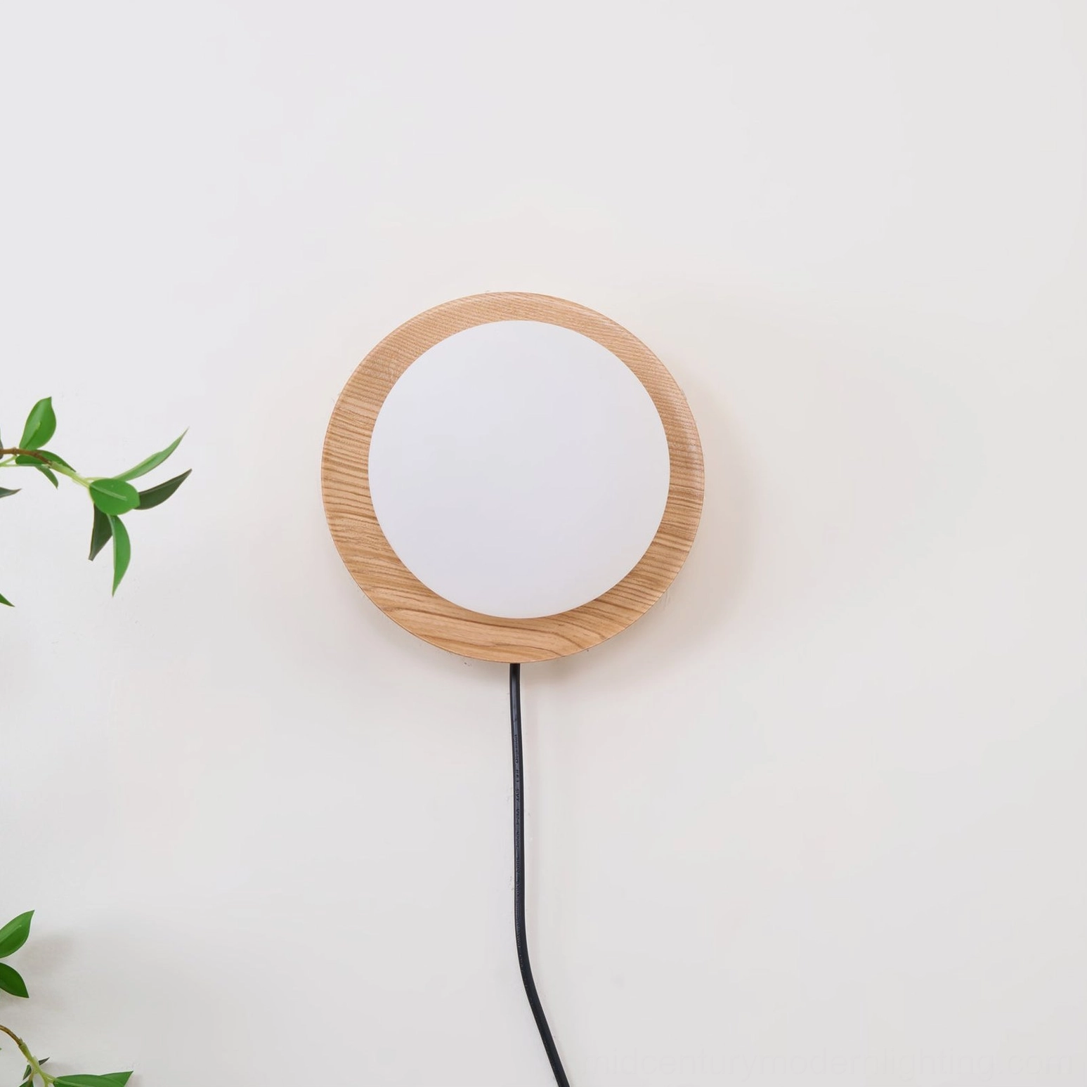Unlit Tablet wall lamp showing half-moon wood frame and round frosted diffuser globe against soft interior wall