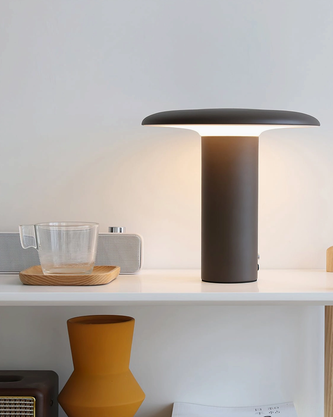 Takku matte black cordless LED mushroom lamp on home shelf with matching modern home accessories