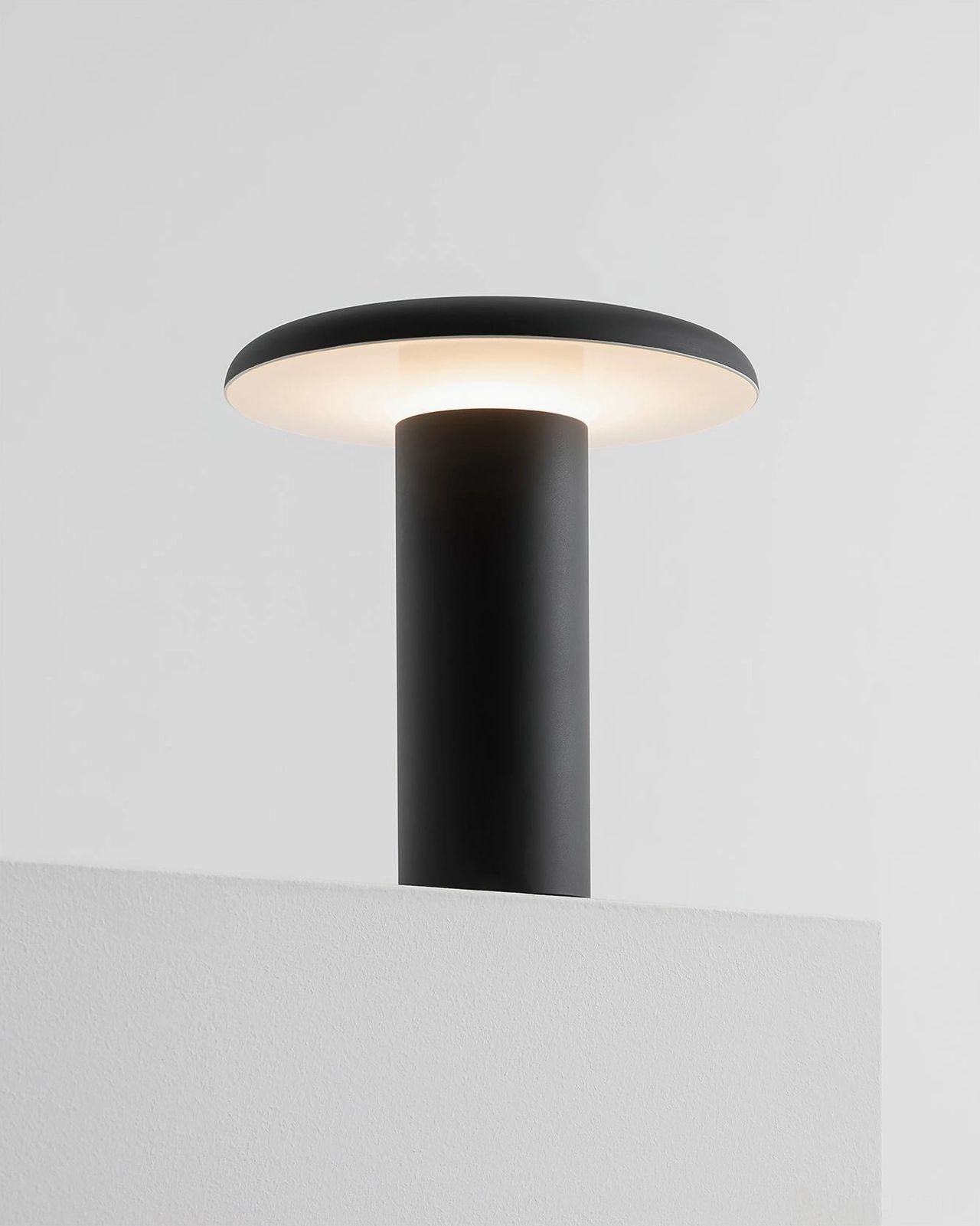 Takku rechargeable cordless lamp styled as bedside reading light with warm ambient illumination