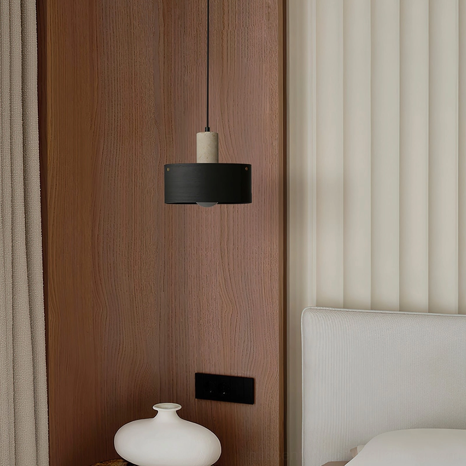 Black and off-white Tako pendant lamp in minimalist bedroom creating soft ambient lighting