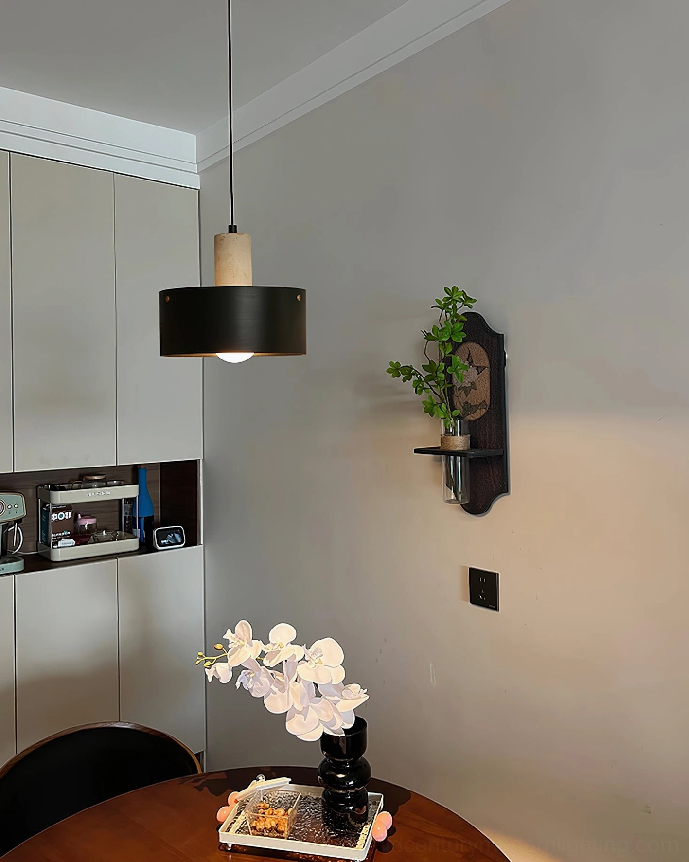 Black and wood-toned Tako pendant lamp in modern kitchen dining zone with warm neutral decor