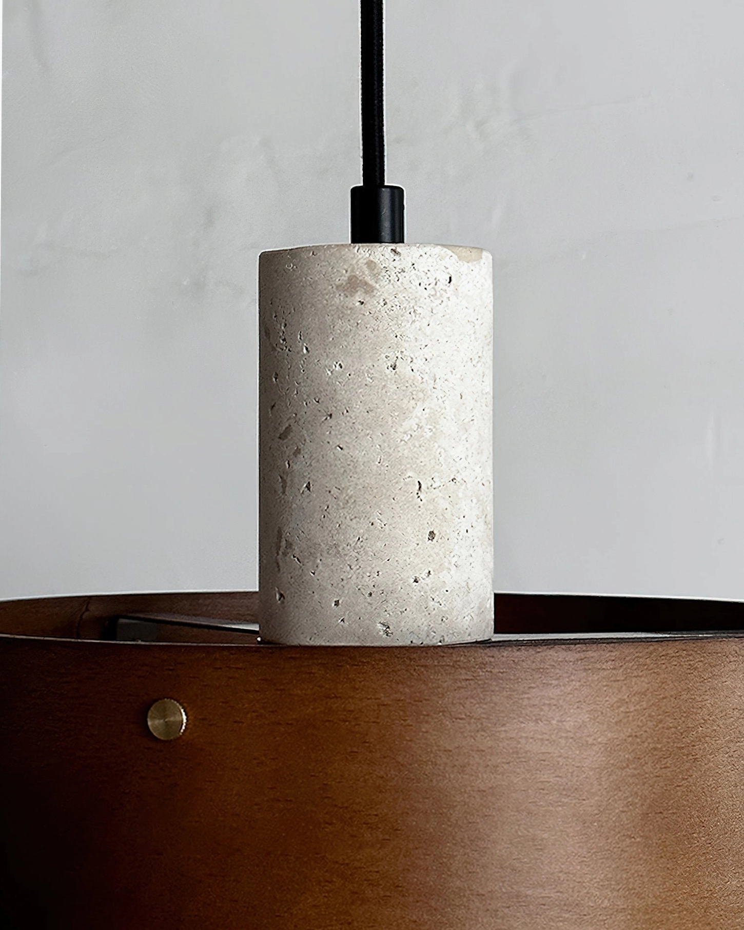 Tako travertine and wood pendant featuring matte finish stone cylinder and warm timber shade